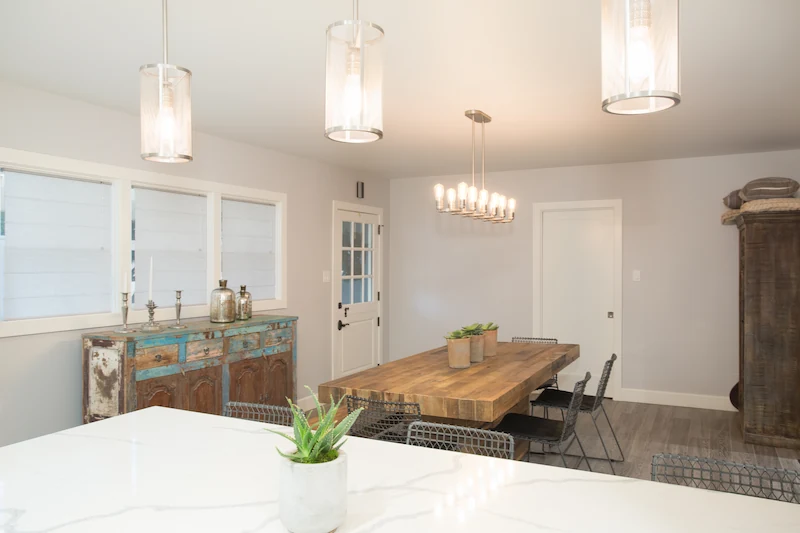 Rustic farmhouse dining room from overlooking kitchen quartz counterop. Photo by Chris Darnall.
