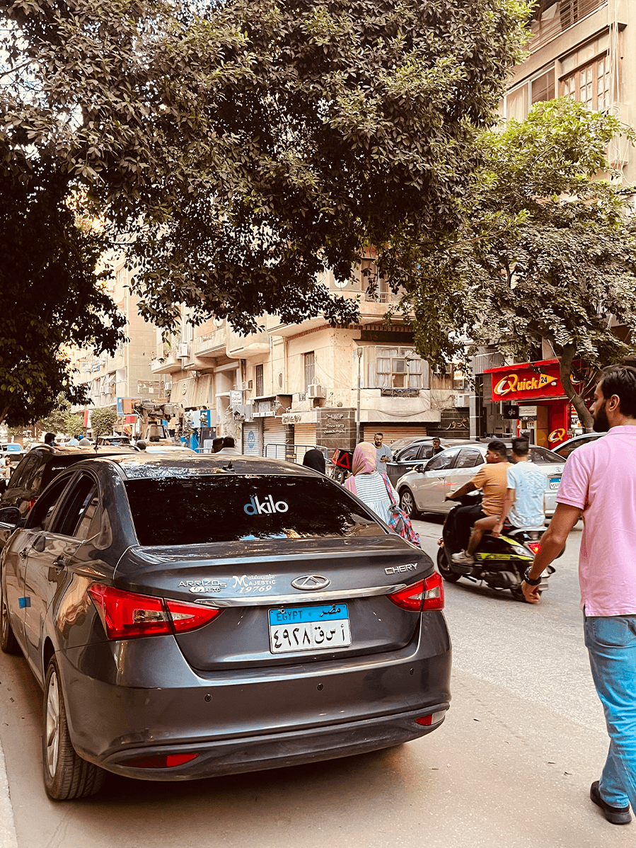 Mobile DOOH advertising vehicle by dKilo driving through a high-traffic neighborhood in Cairo.