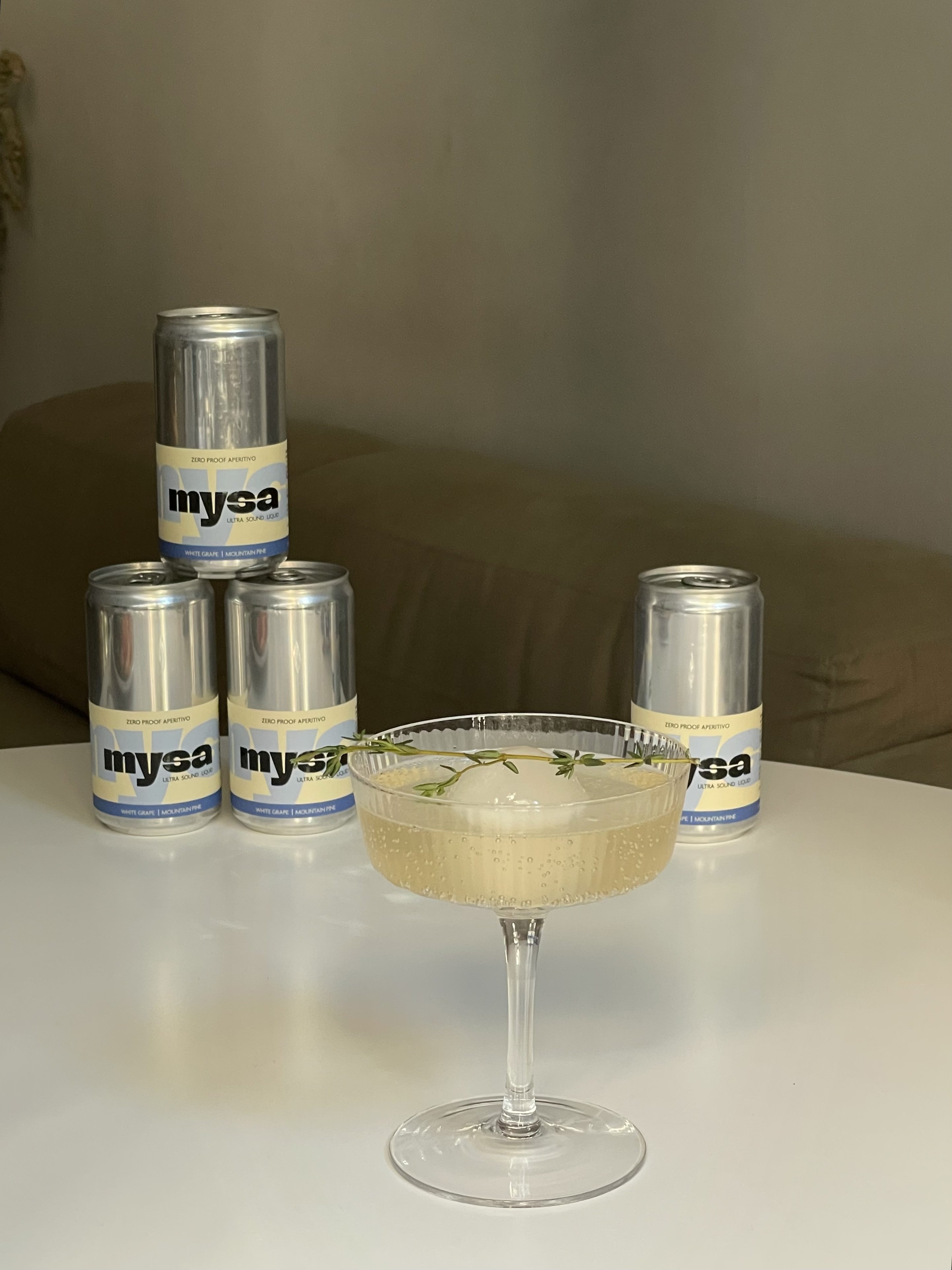 close-up of mysa served in a crystal coupe glass with a chili and square ice cube