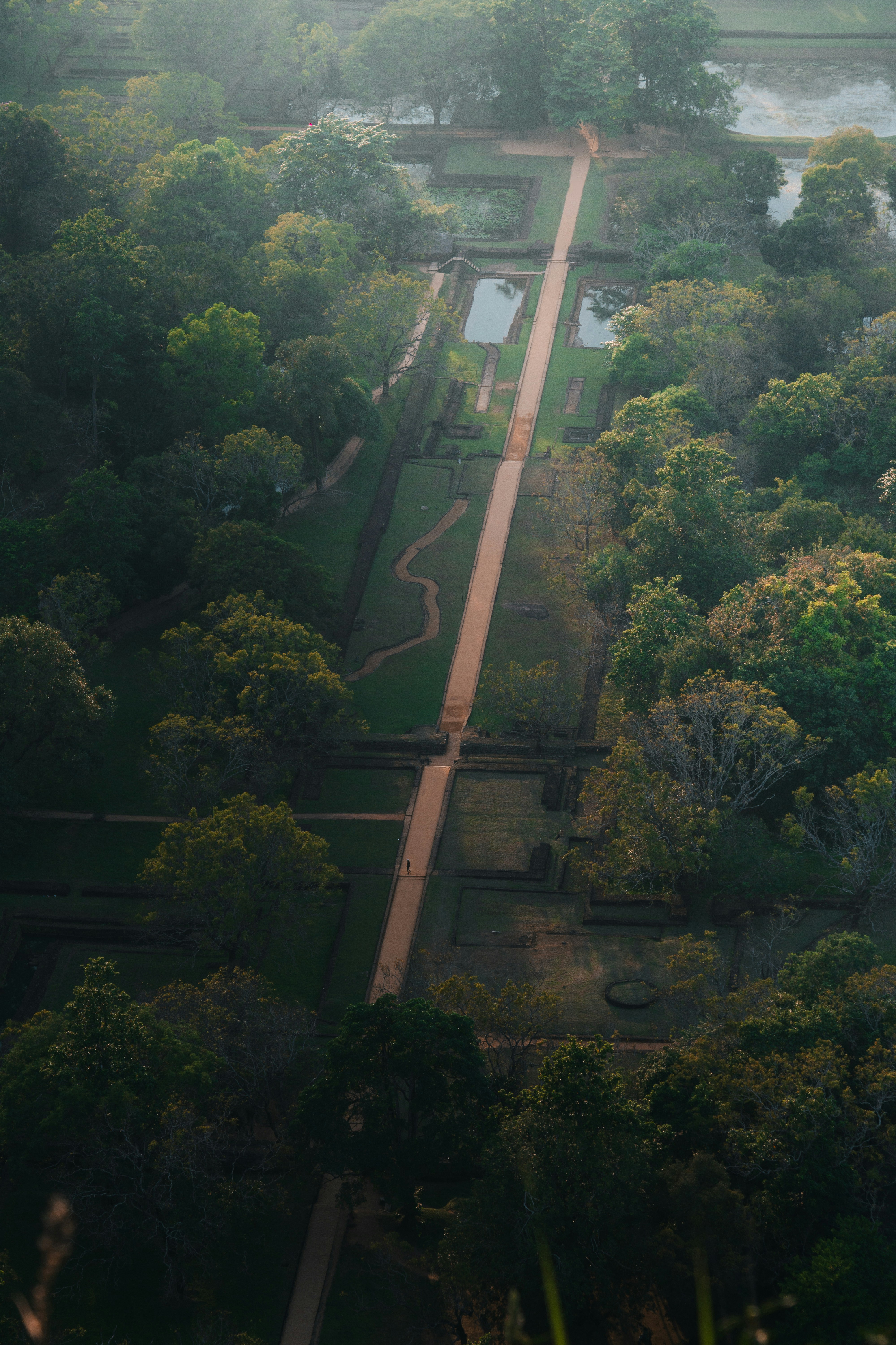red train travelling near body of water