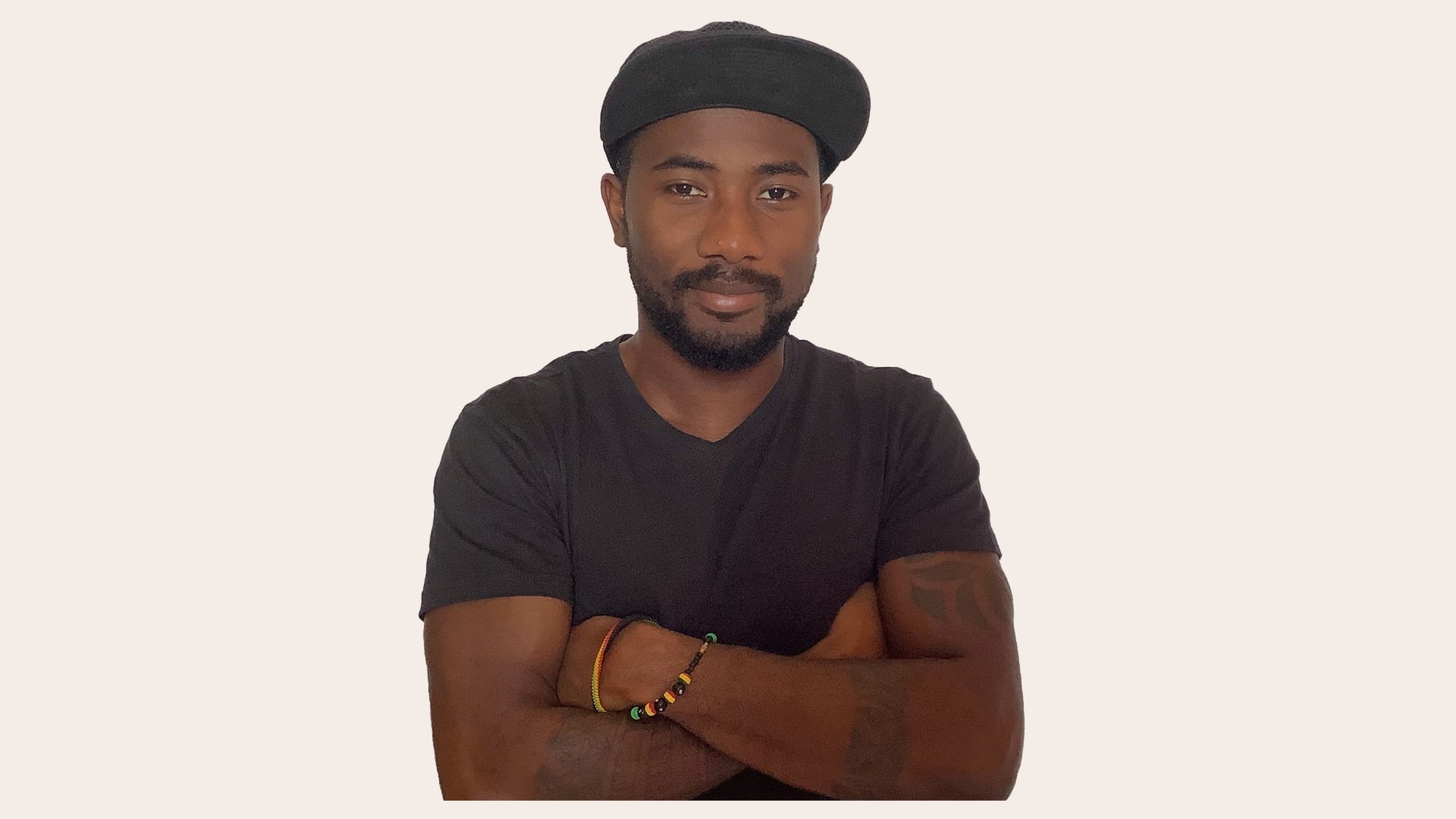 A young person with long, wavy hair sits in front of a plain background, looking directly at the camera.