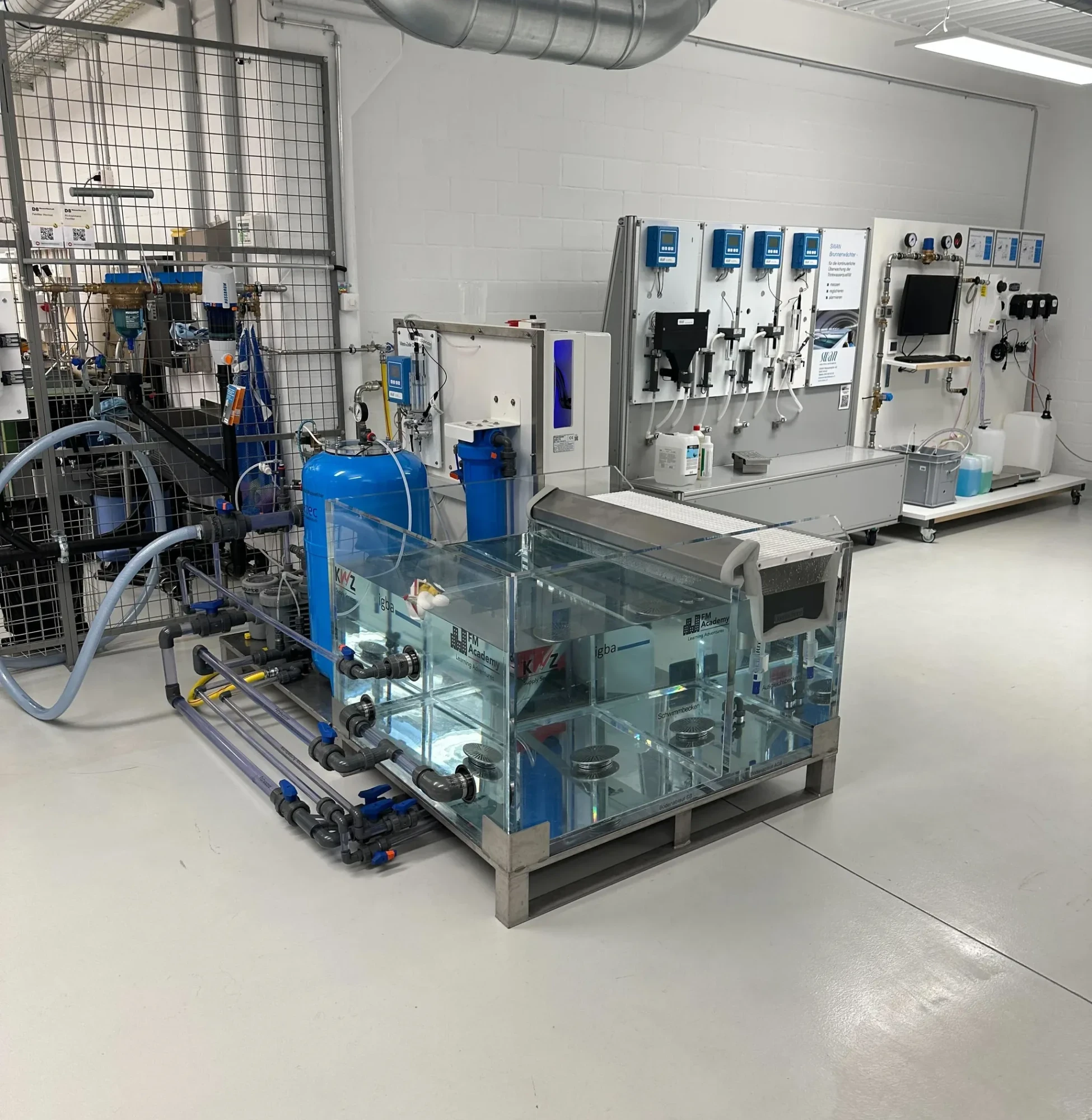 Modern water treatment laboratory with transparent testing tanks, monitoring systems, and chemical analysis equipment for advanced pool management.