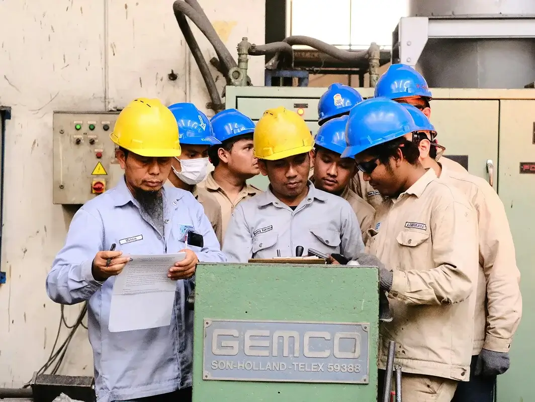 a group of men wearing hard hats standing next to each other