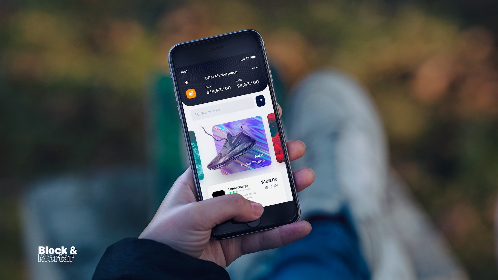 Lifestyle mockup of Block & Mortar offer marketplace on smartphone showing featured Nike LunarCharge sneakers at $199, cryptocurrency balance display ($14,927 OEX, $4,837 BMC), and swipeable product carousel against autumn outdoor background