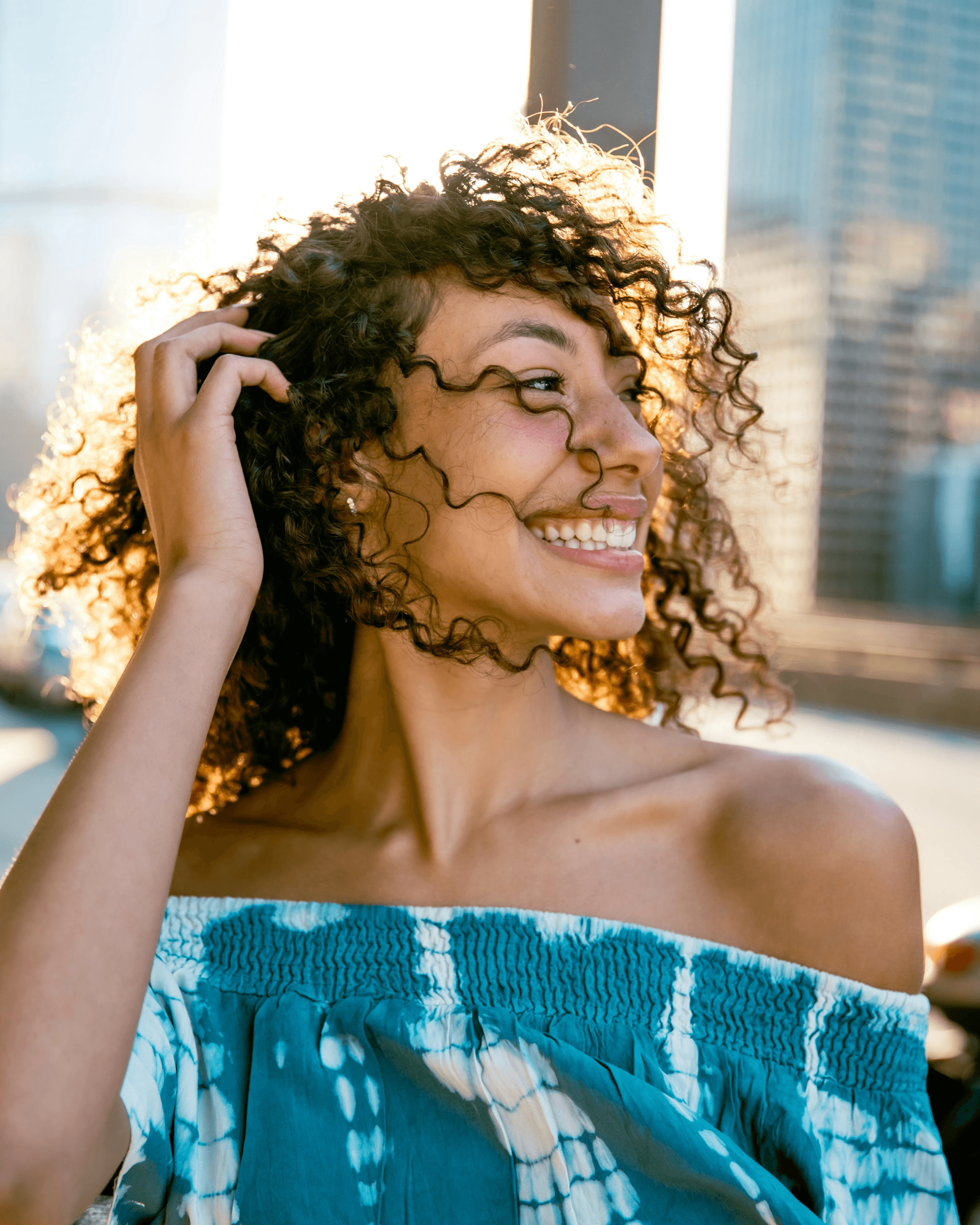 woman in blue tube dress smiling