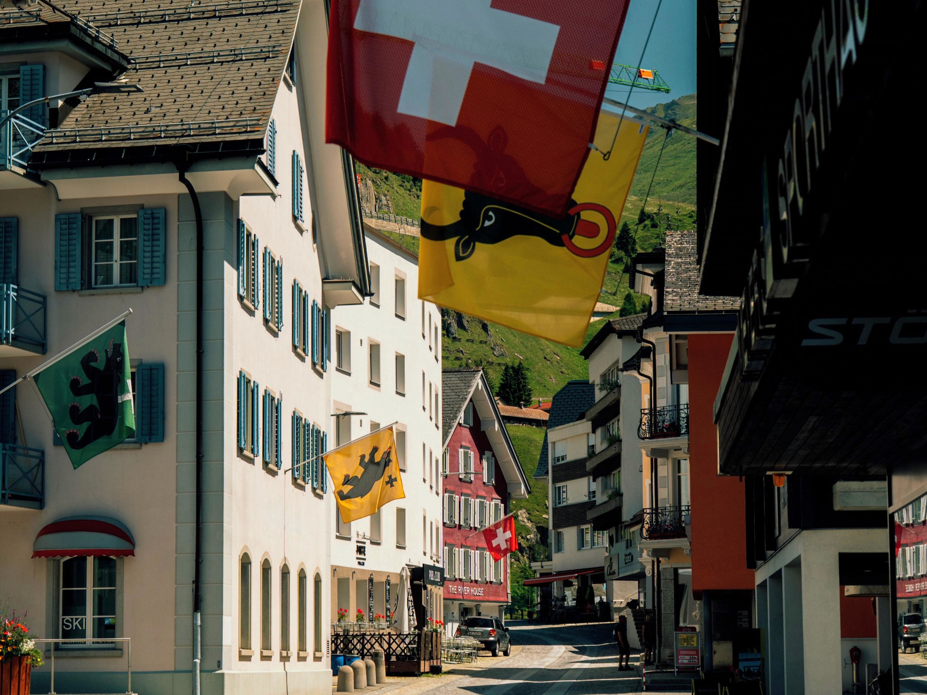 Andermatt old town with a variety of colourful Swiss flags