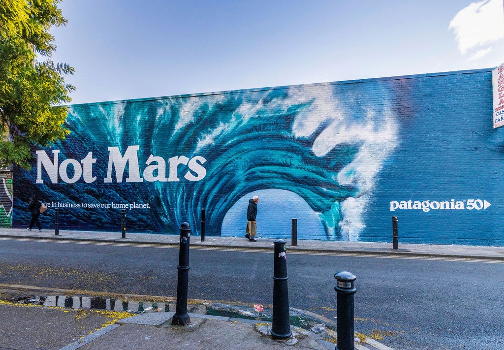 Woman wears a blue coat in a blue environment.