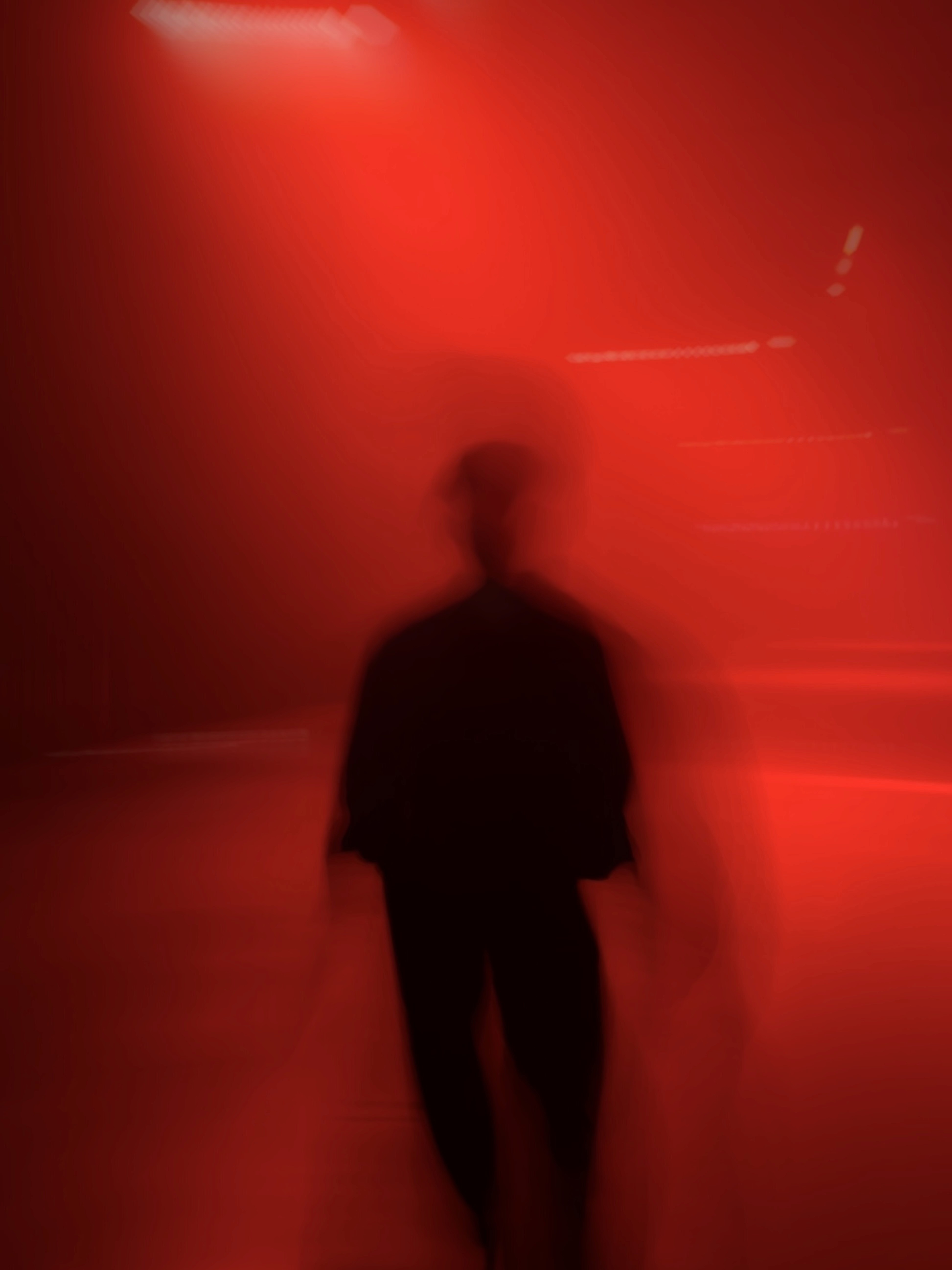 a blurry photo of a person standing in front of a wall