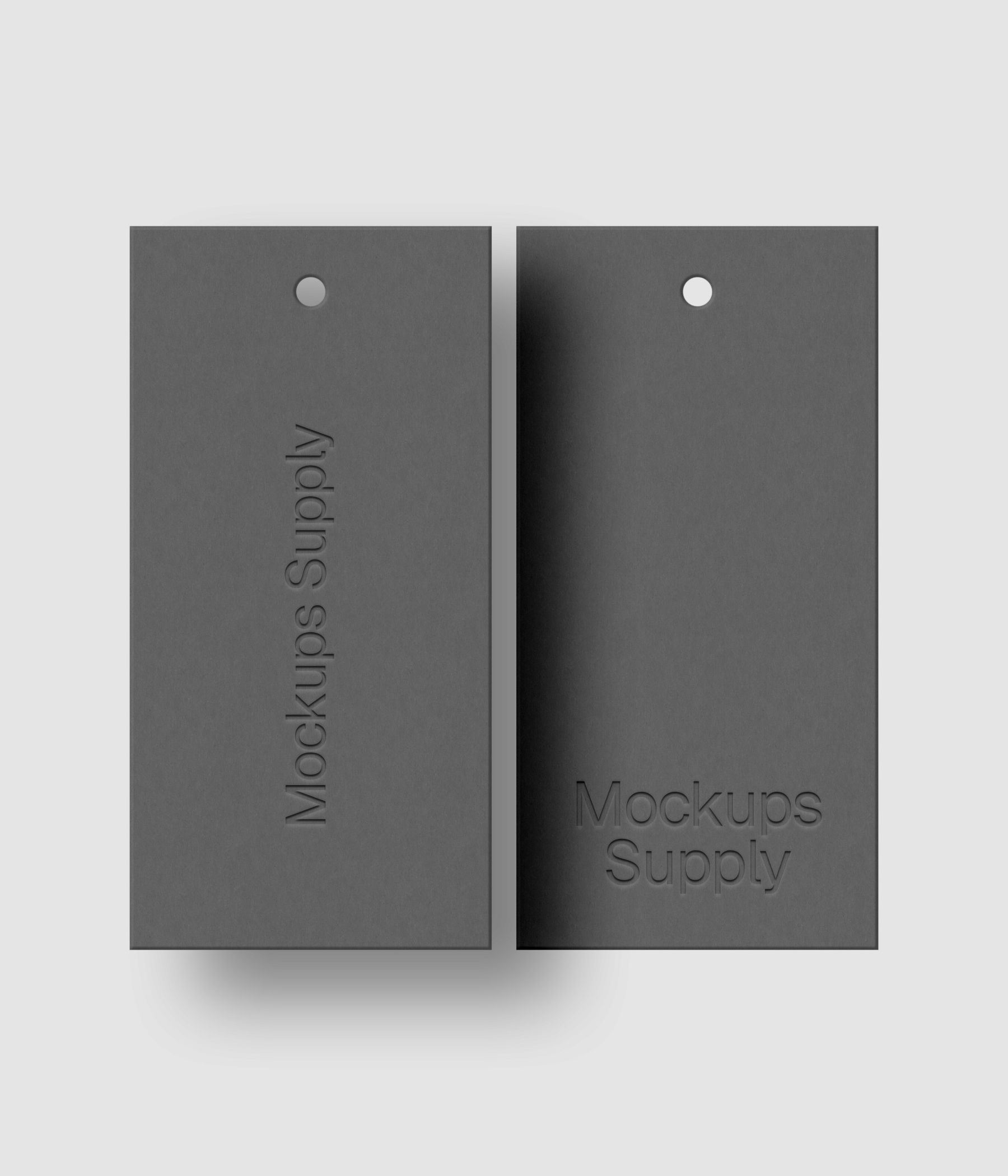 Two gray 1x2 hang tags mockup on white background with realistic debossed logo effect and natural shadow depth for Photoshop download psd