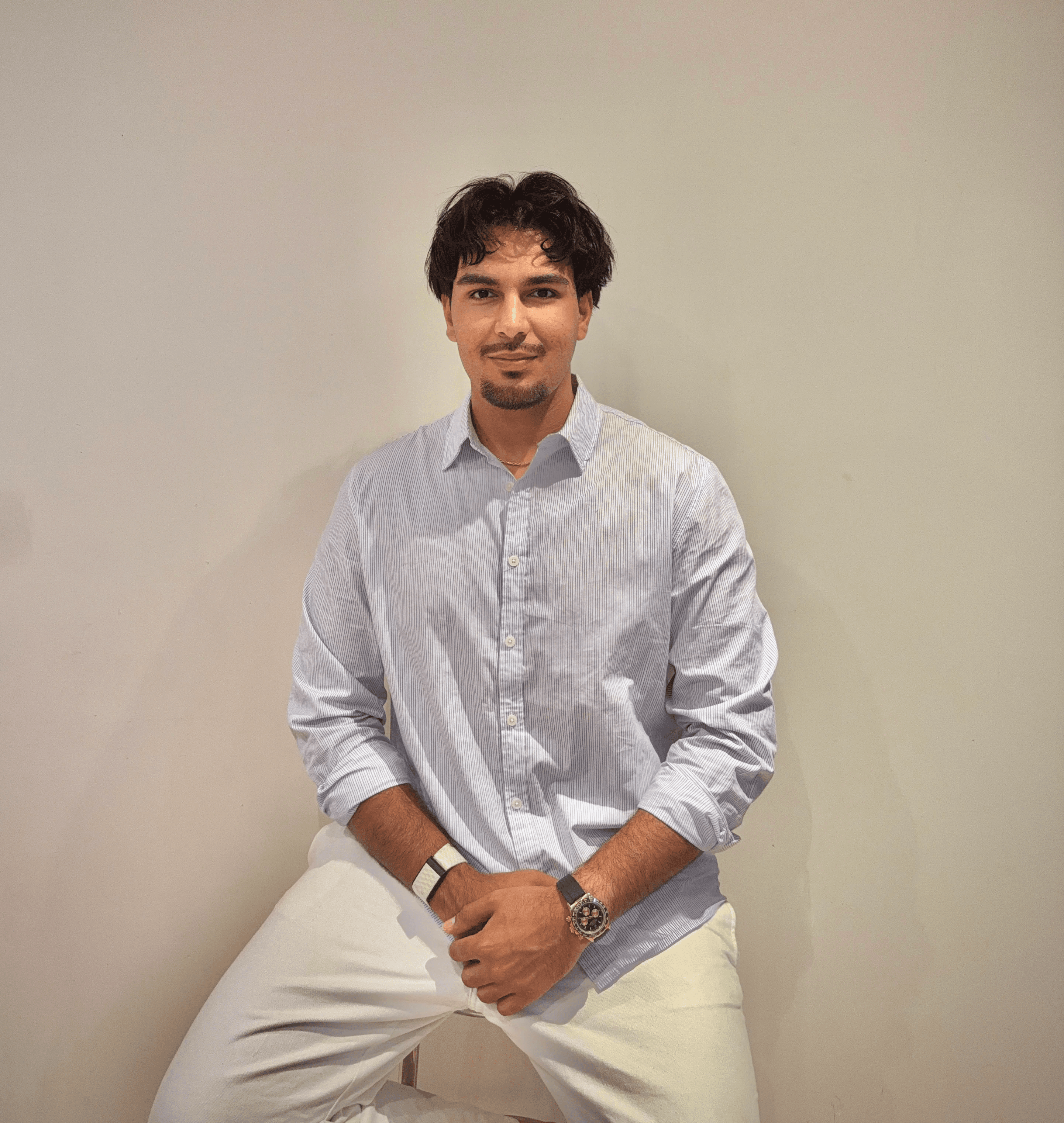 Portrait of a person in dark clothing speaking on a phone