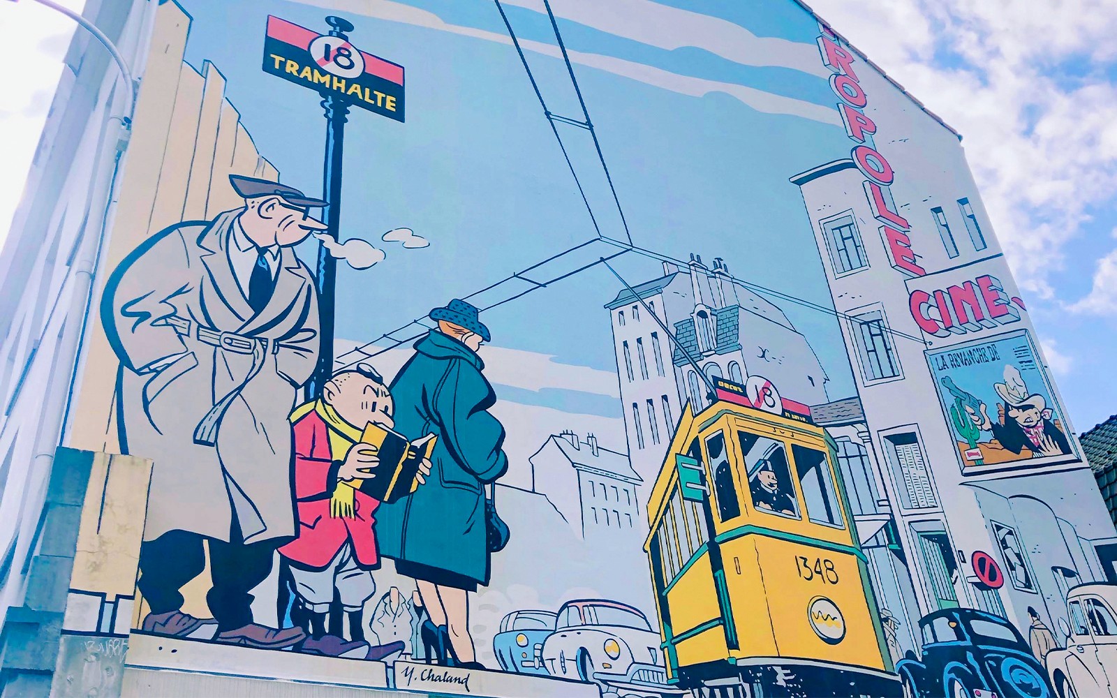Comic-style mural in Brussels featuring a tram and pedestrians, highlighting urban life.