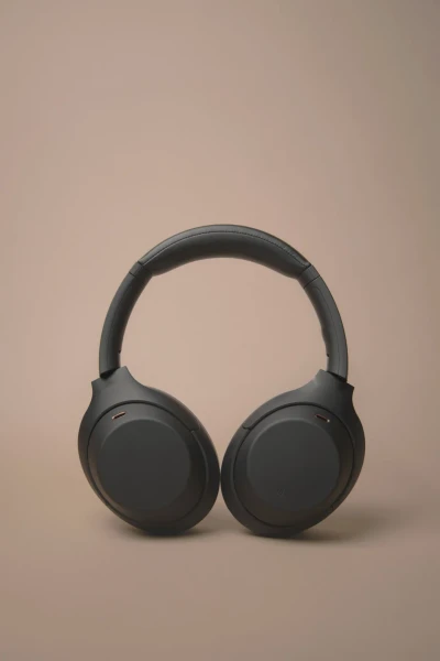Black headphones on a taupe sweep