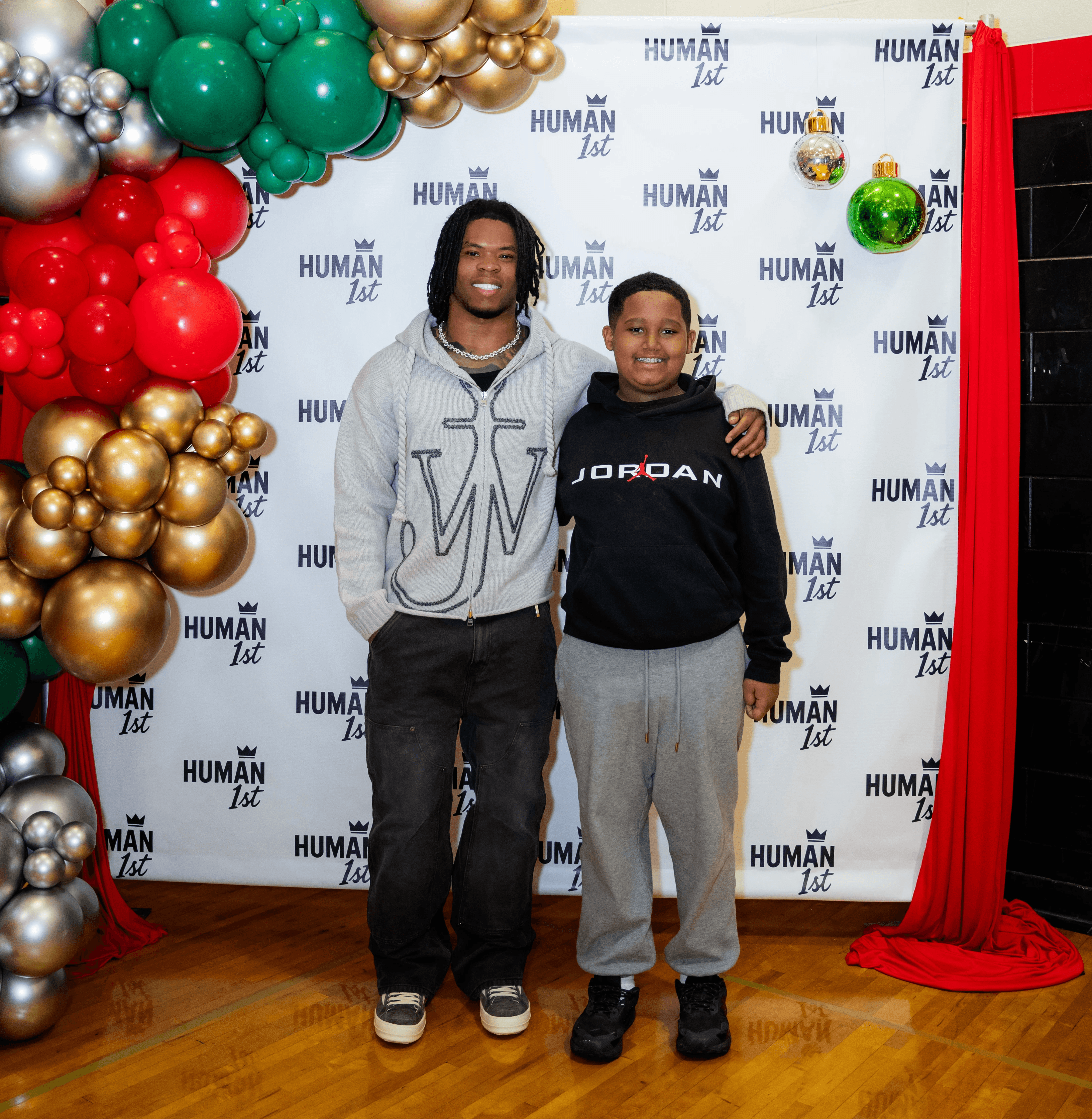 five children smiling while doing peace hand sign
