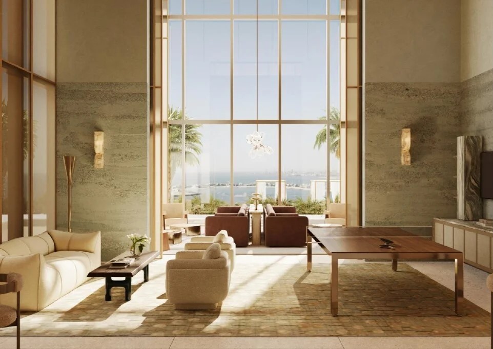 Sun-drenched lounge with double-height windows and ocean views. A masterpiece of residential luxury.