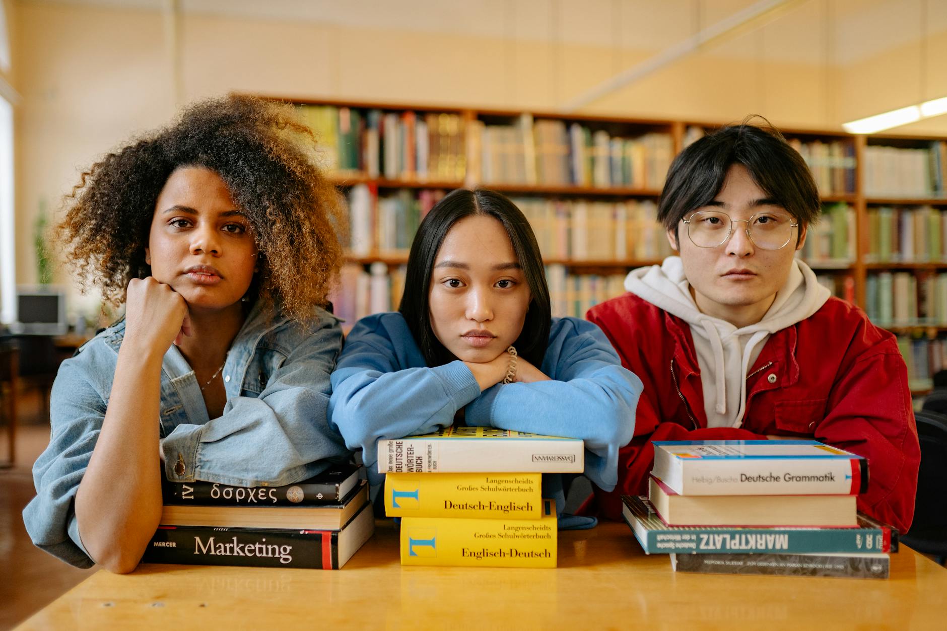 A classroom library shelf displaying a wide variety of colorful book spines featuring diverse characters and global flags.