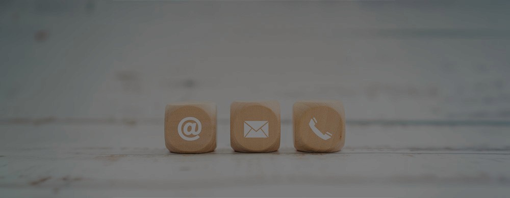 two people in a workspace working on their laptops 