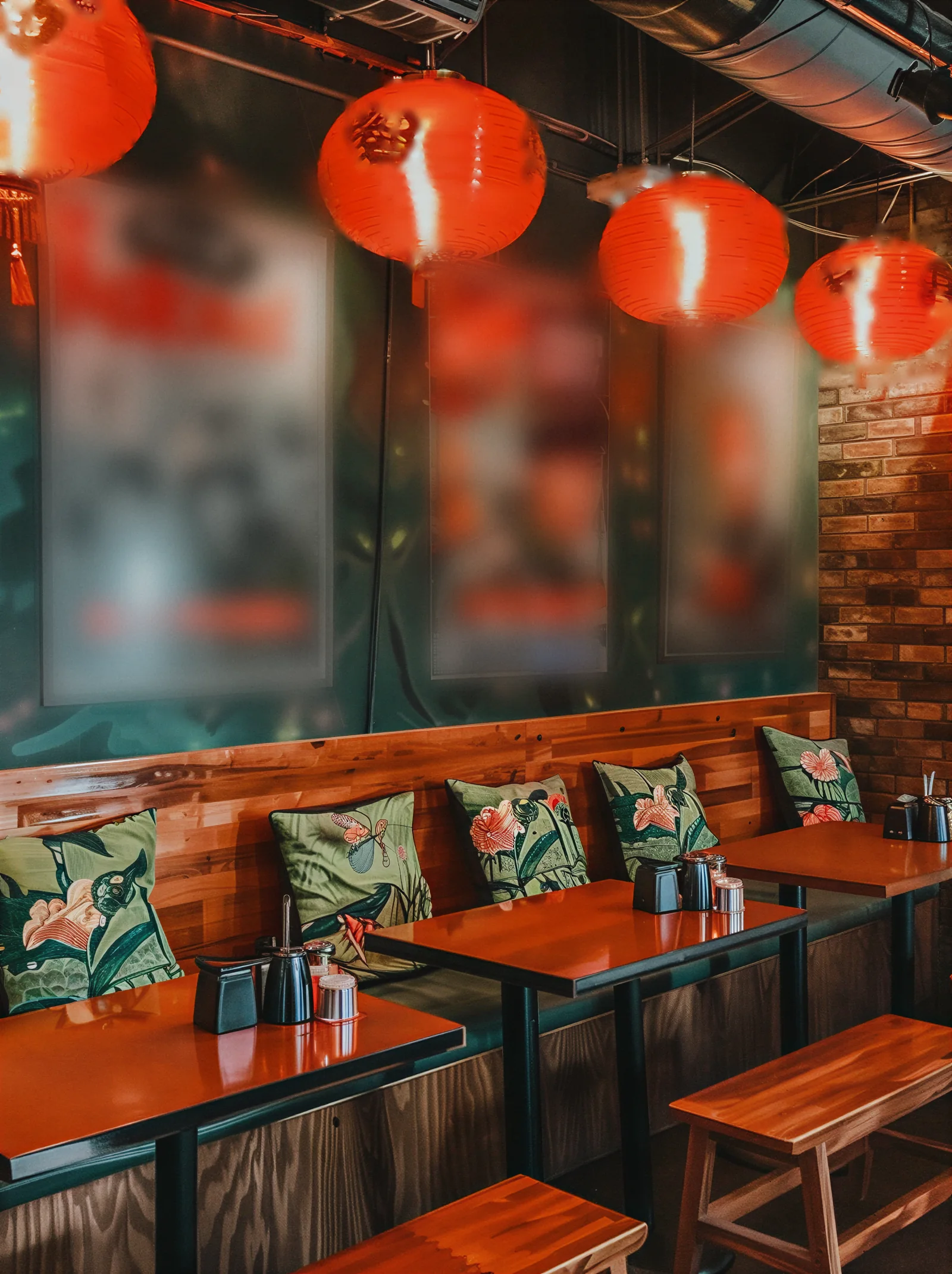 A red-lantern dining room with wooden booths
