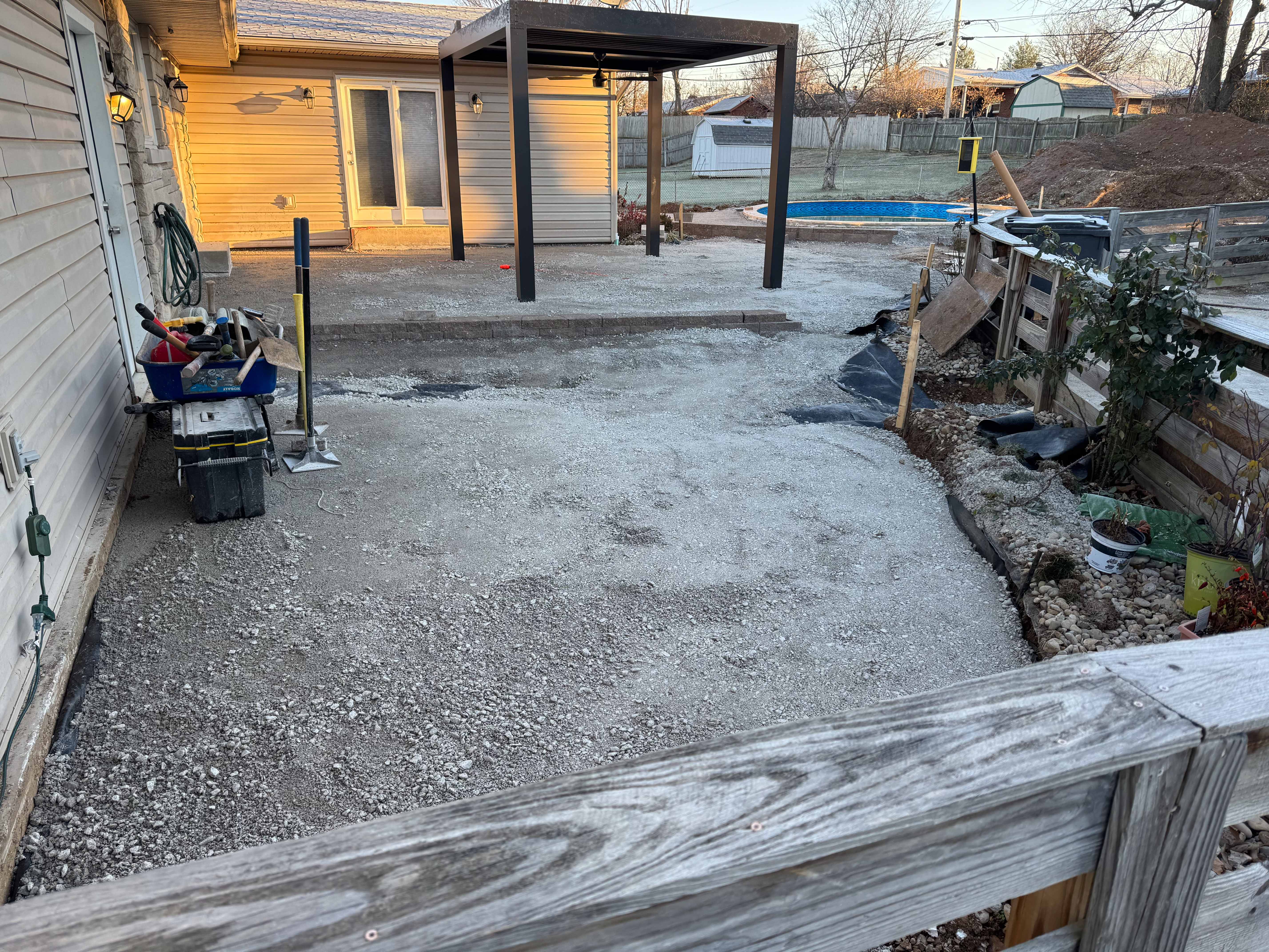 Pool installation in progress with compacted gravel base