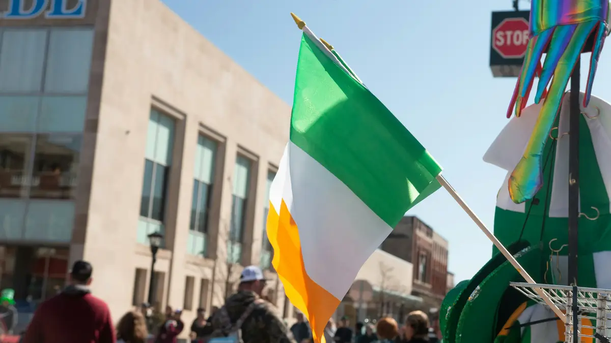 Irish flag waving at a sunny street parade