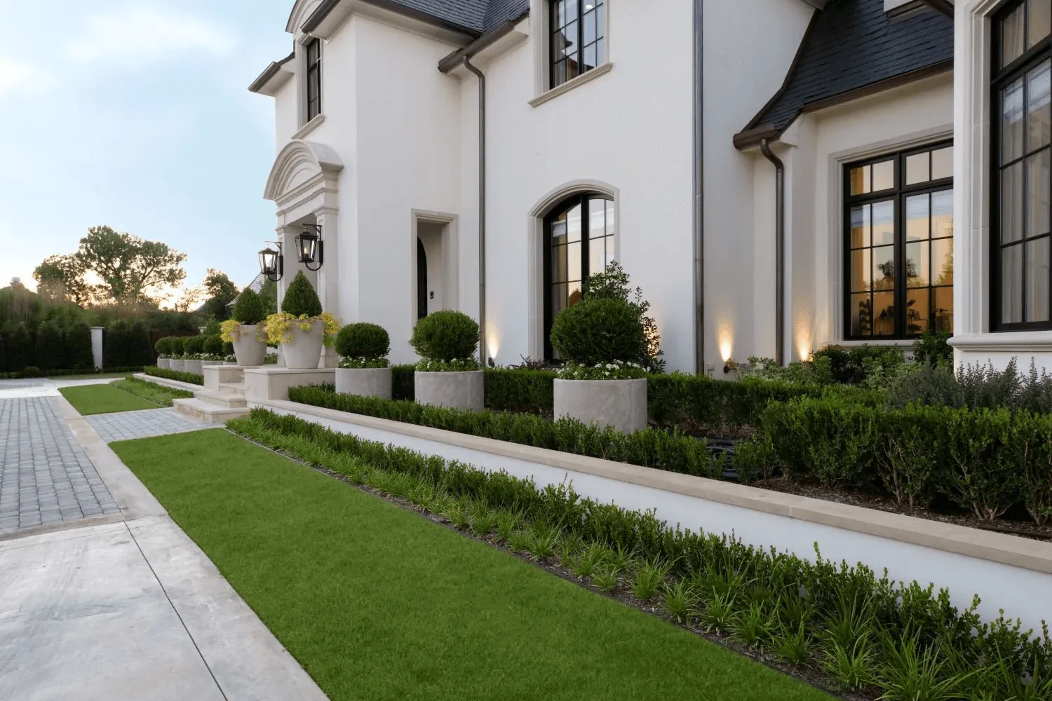 Formal front garden design with sculptural fountains for luxury Preston Hollow Dallas estate - photo from side angle