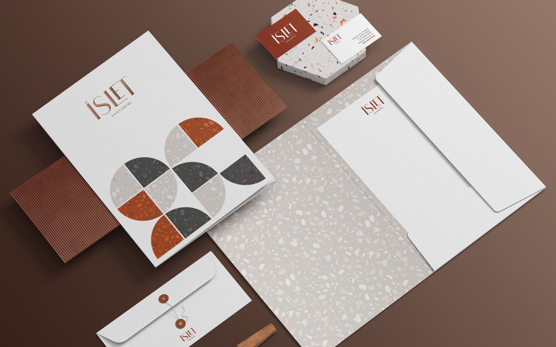 Complete stationery design for ISLET Santorini, combining minimal graphics with natural textures
