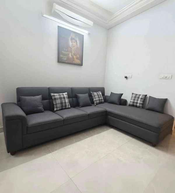 Custom three‑seater beige upholstered sofa set with matching armchairs and wooden frame