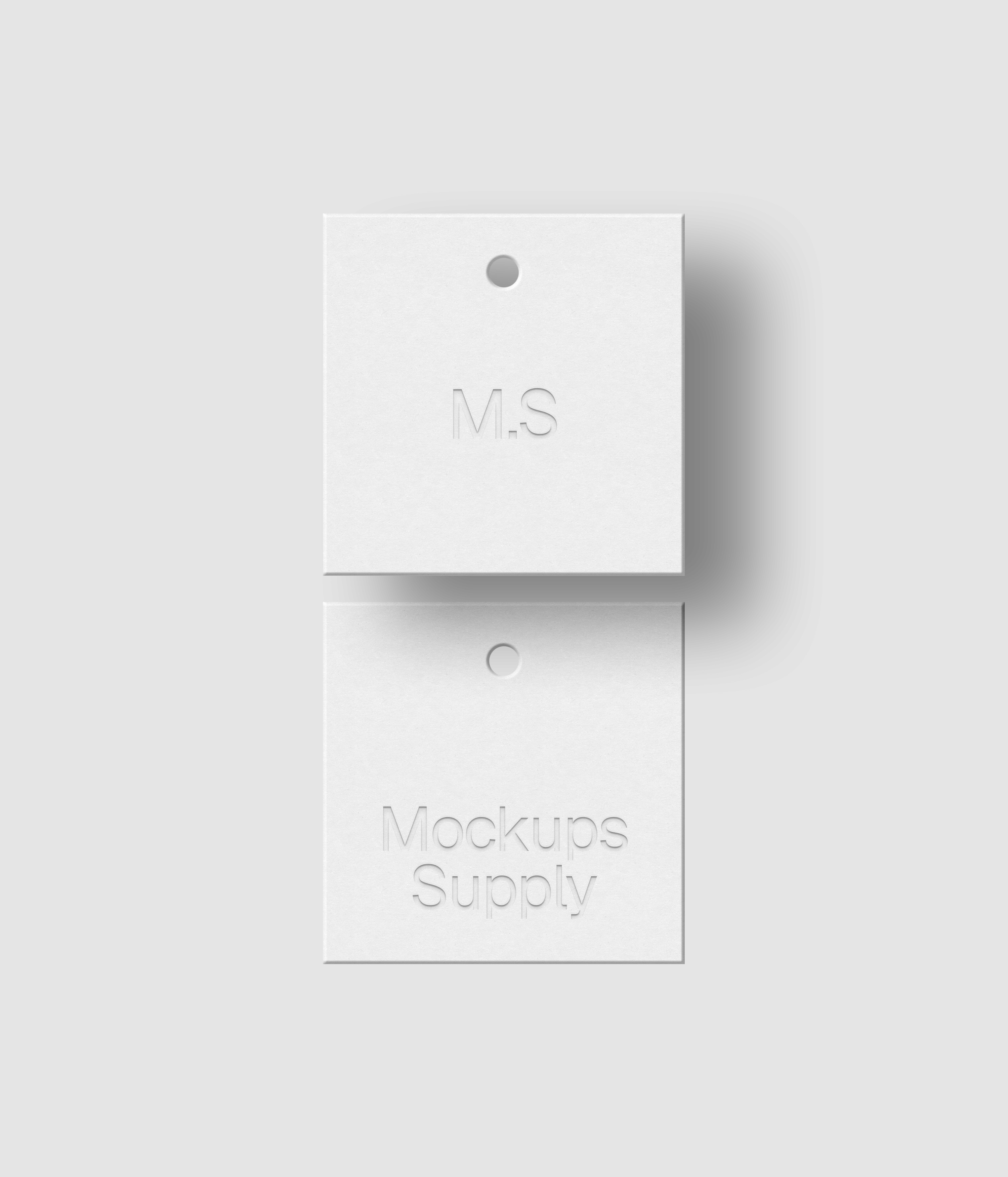 Two square white hang tags mockup on white background with soft shadow and debossed text effect for Photoshop download psd