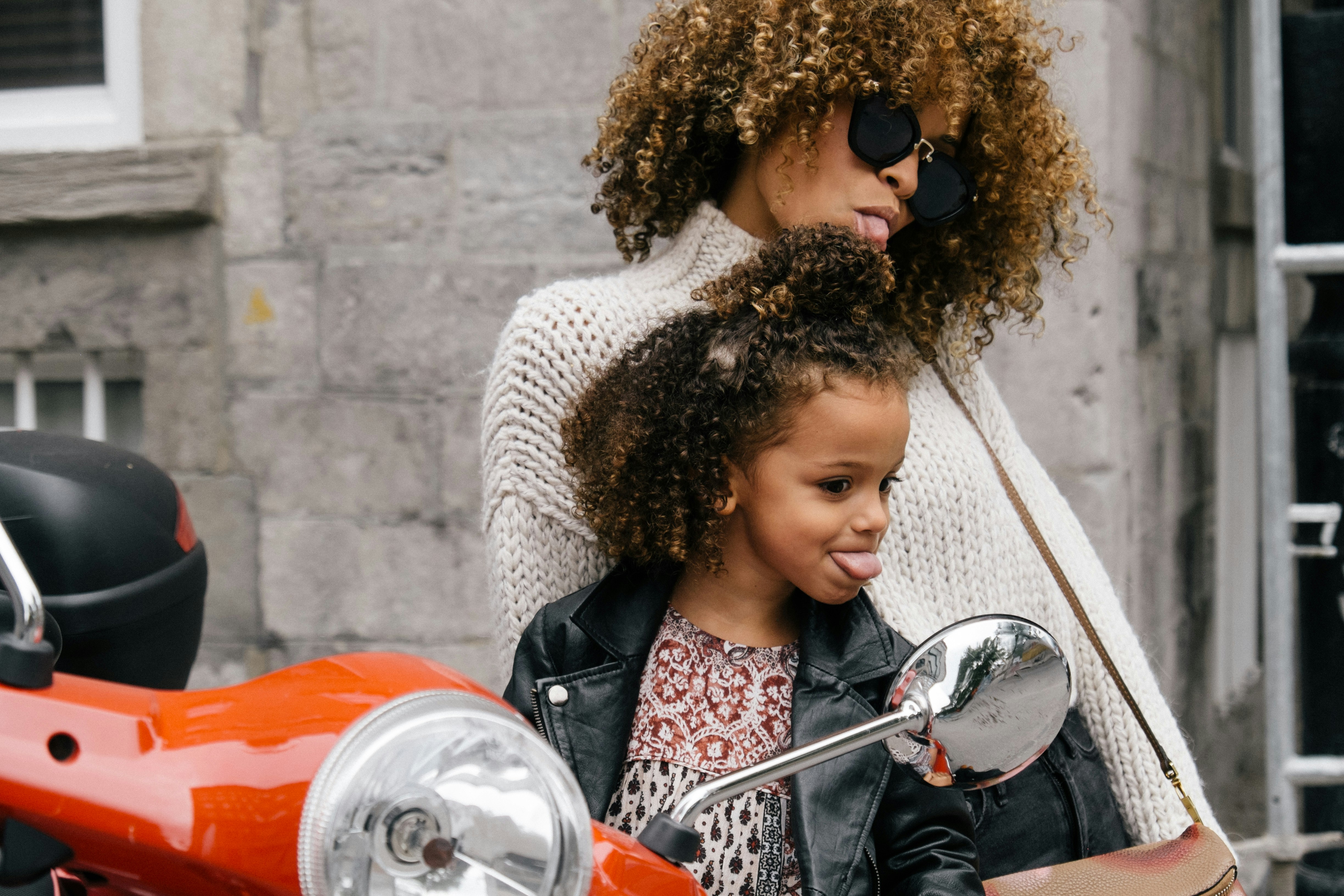 A mother and her daughter with curly hair