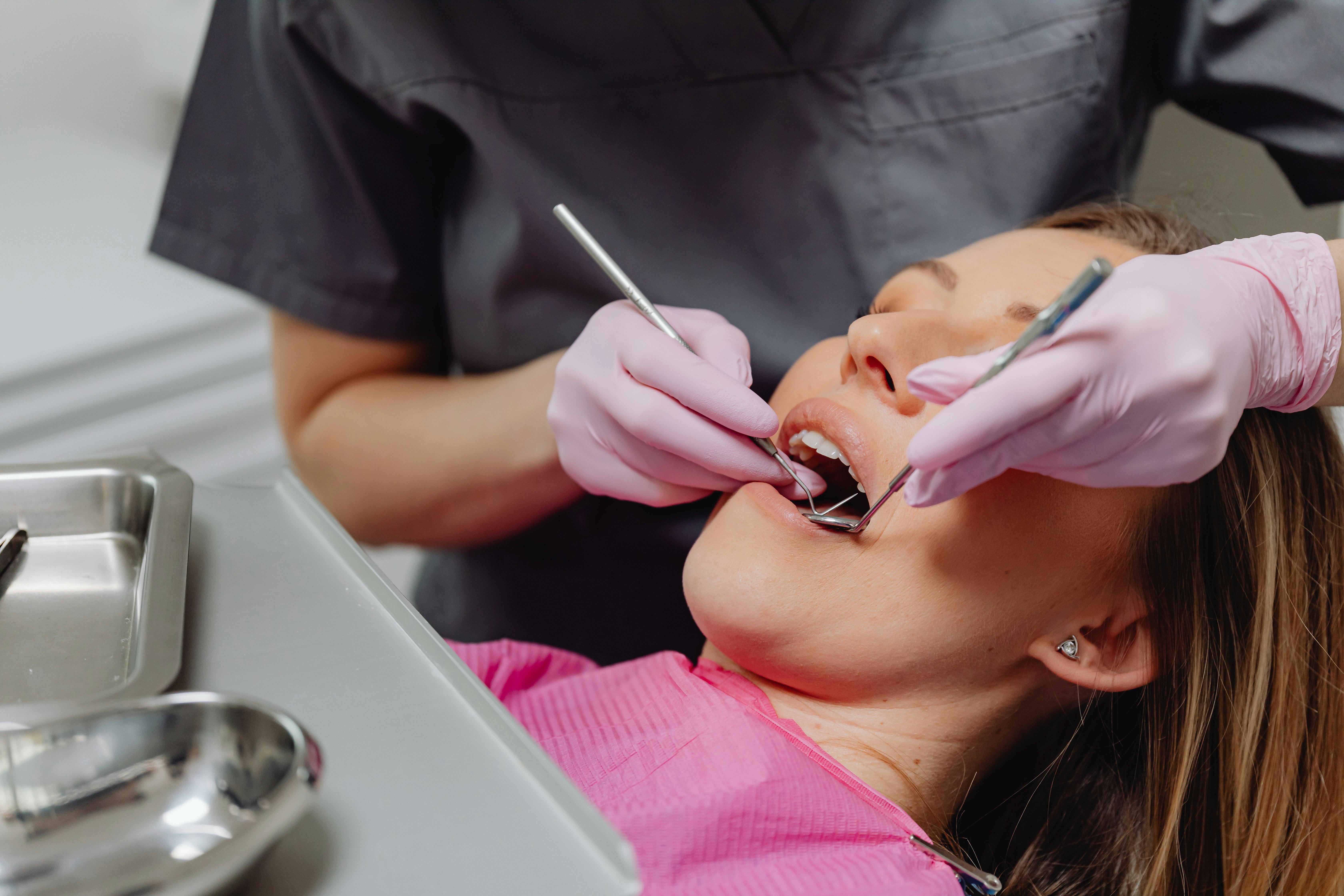 Dental hygienist working on female patient