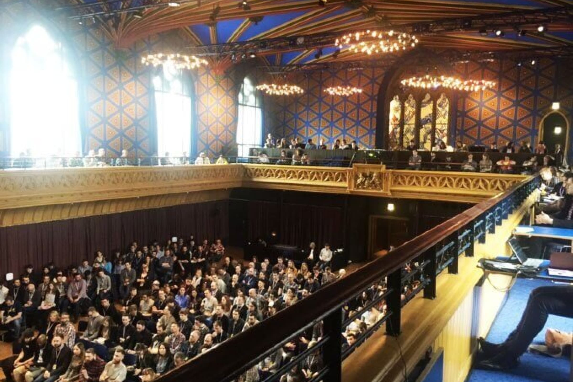 A group of people sitting in a conference venue