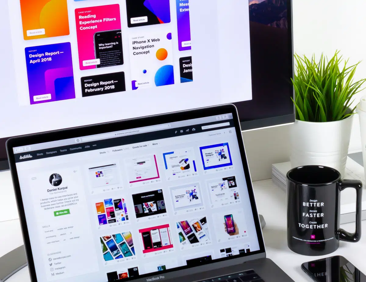 black and gray laptop computer beside black mug