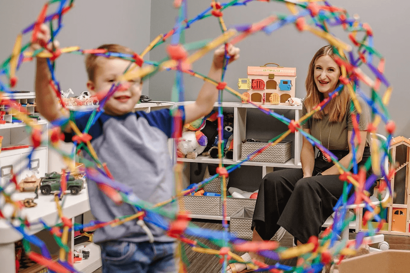 Child building with blocks during play therapy session in Dallas with licensed counselor