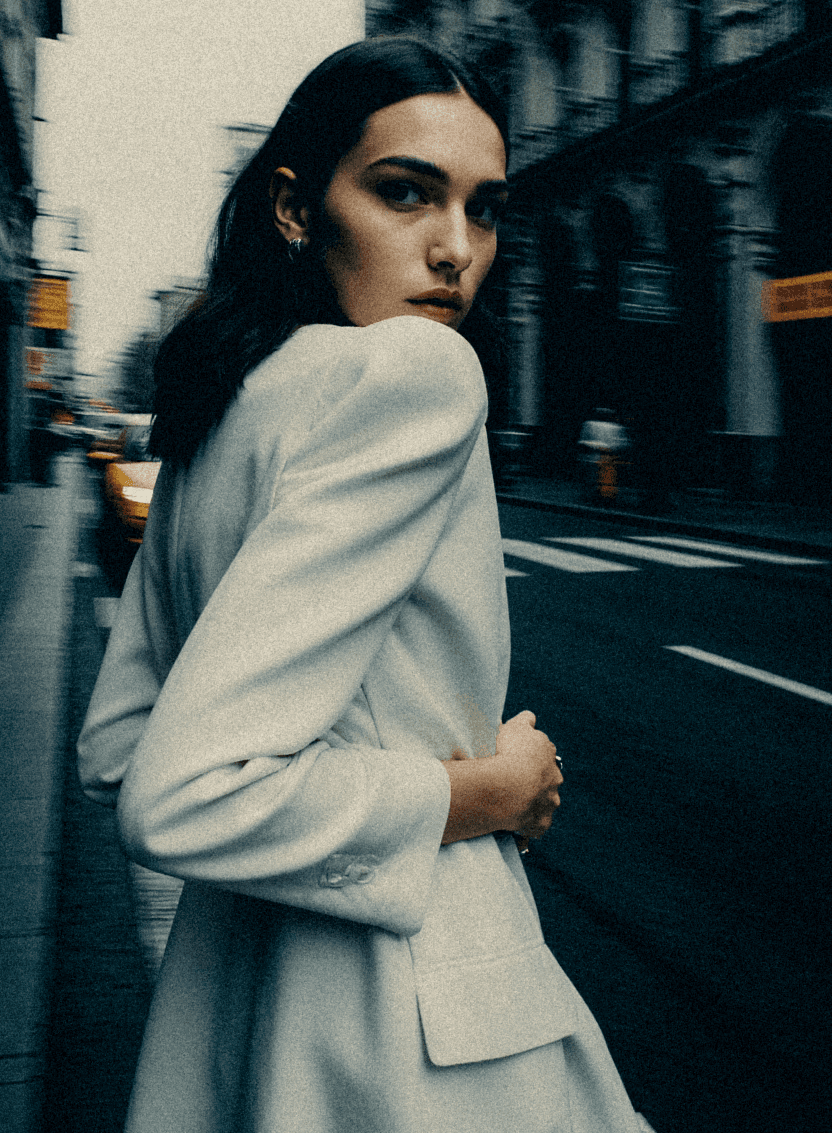 Corporate woman walking in the middle of a downtown street with motion blur