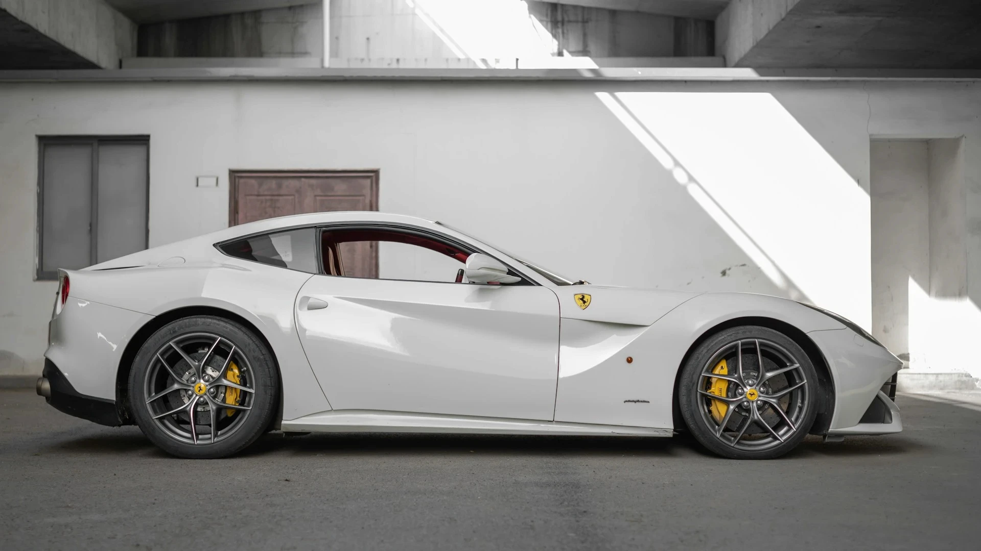 a white sports car parked in a garage