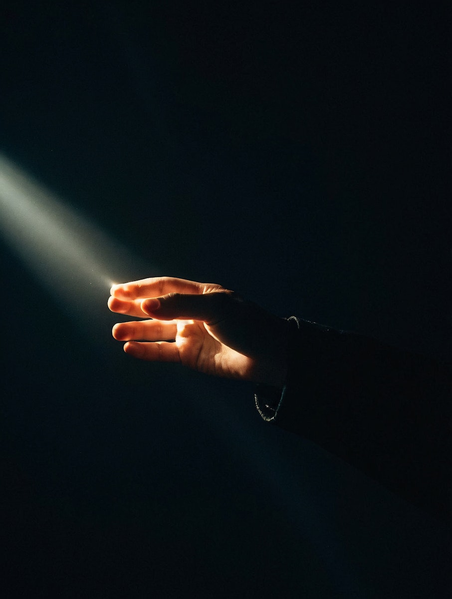 girl in blue jacket holding red and silver ring