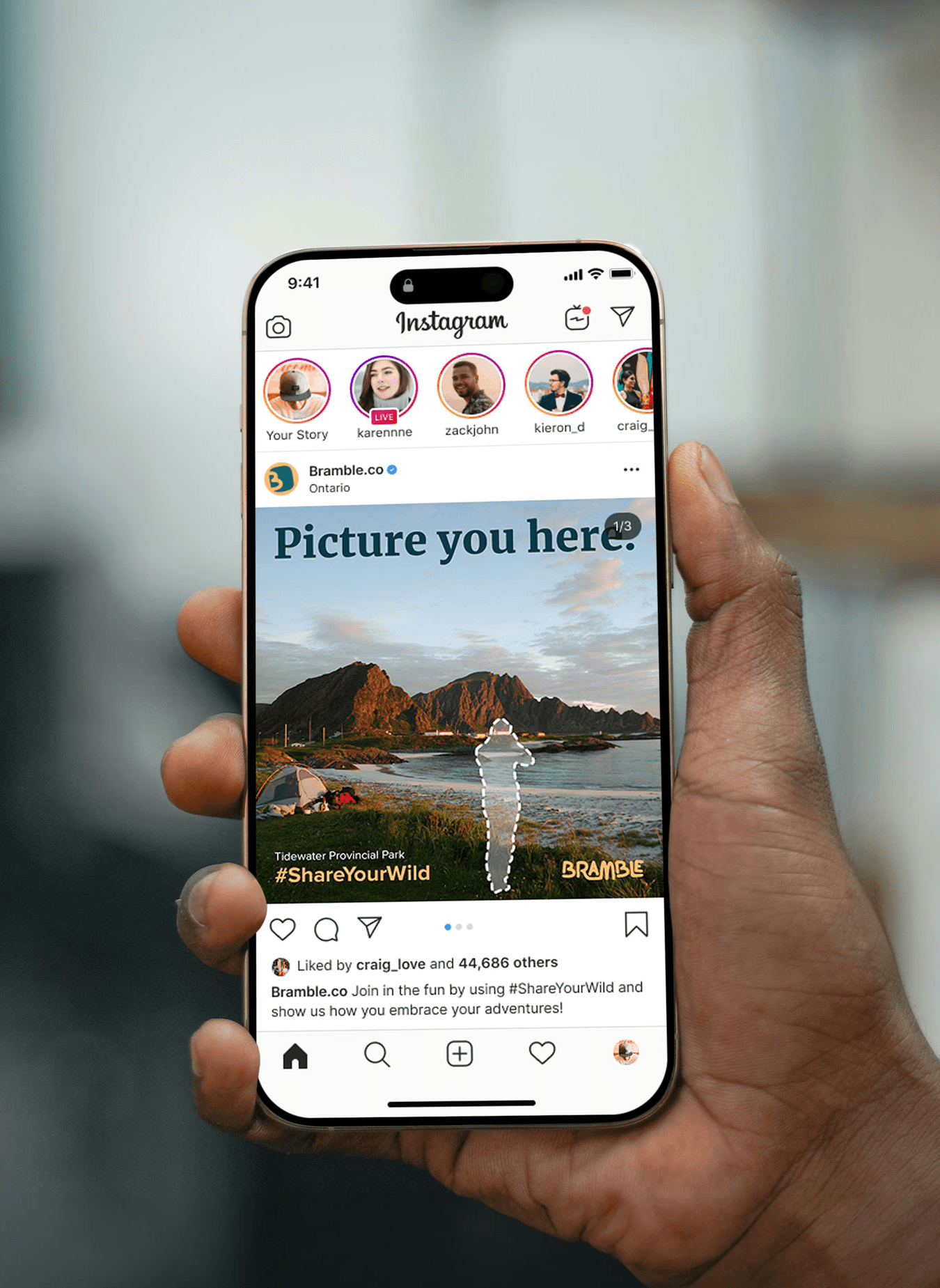 Hand holding a phone with an instagram post on the screen