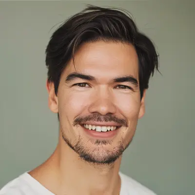 Dark-haired man smiling, natural light, landscaping client testimonial portrait