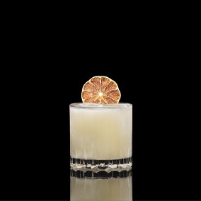 A closeup of a Bananarama drink against a dark background.