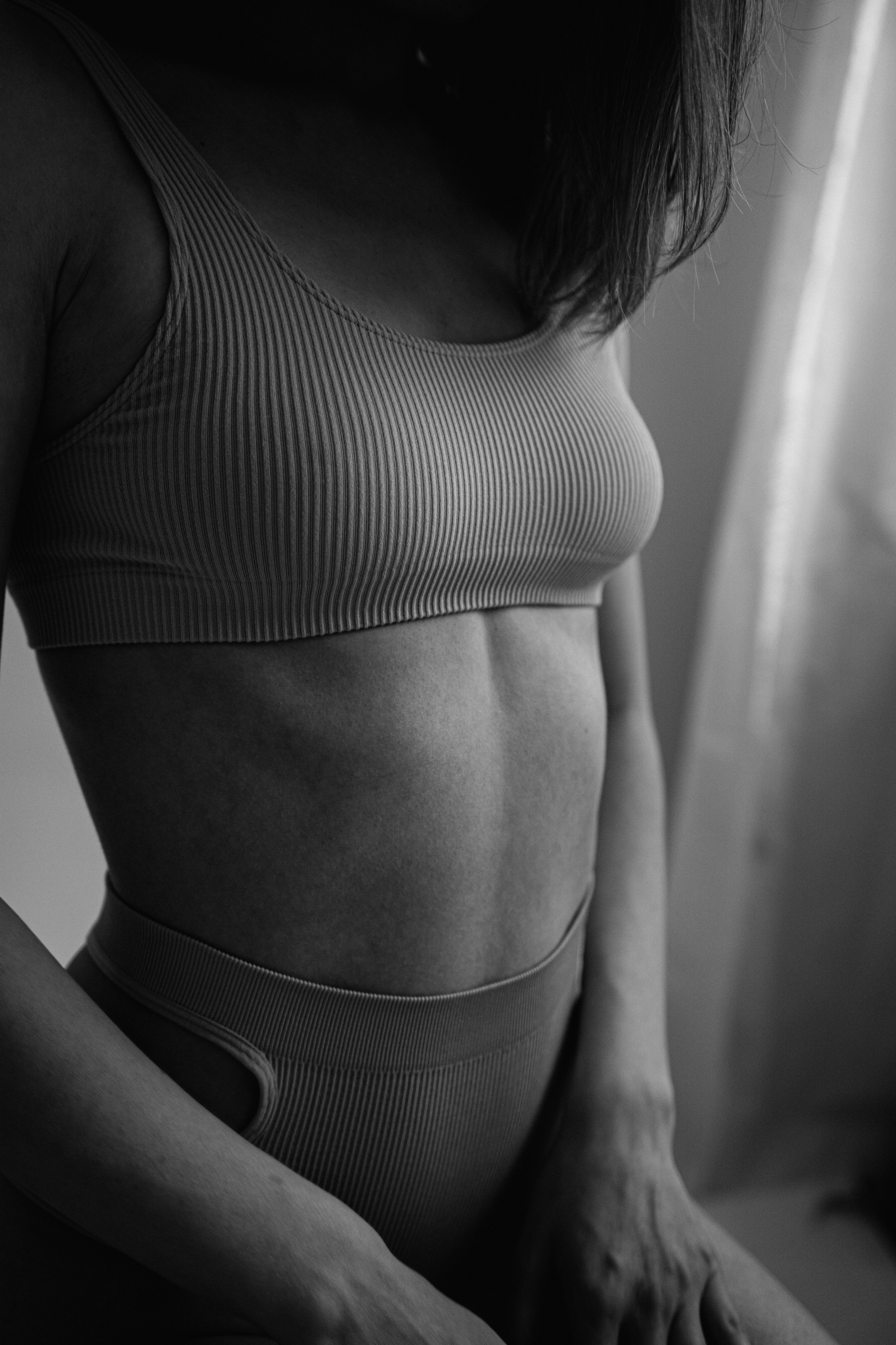 A wooden essential oil diffuser releasing a gentle stream of steam, surrounded by dried herbs and a small bottle of essential oil. The warm lighting enhances the cozy and therapeutic ambiance.