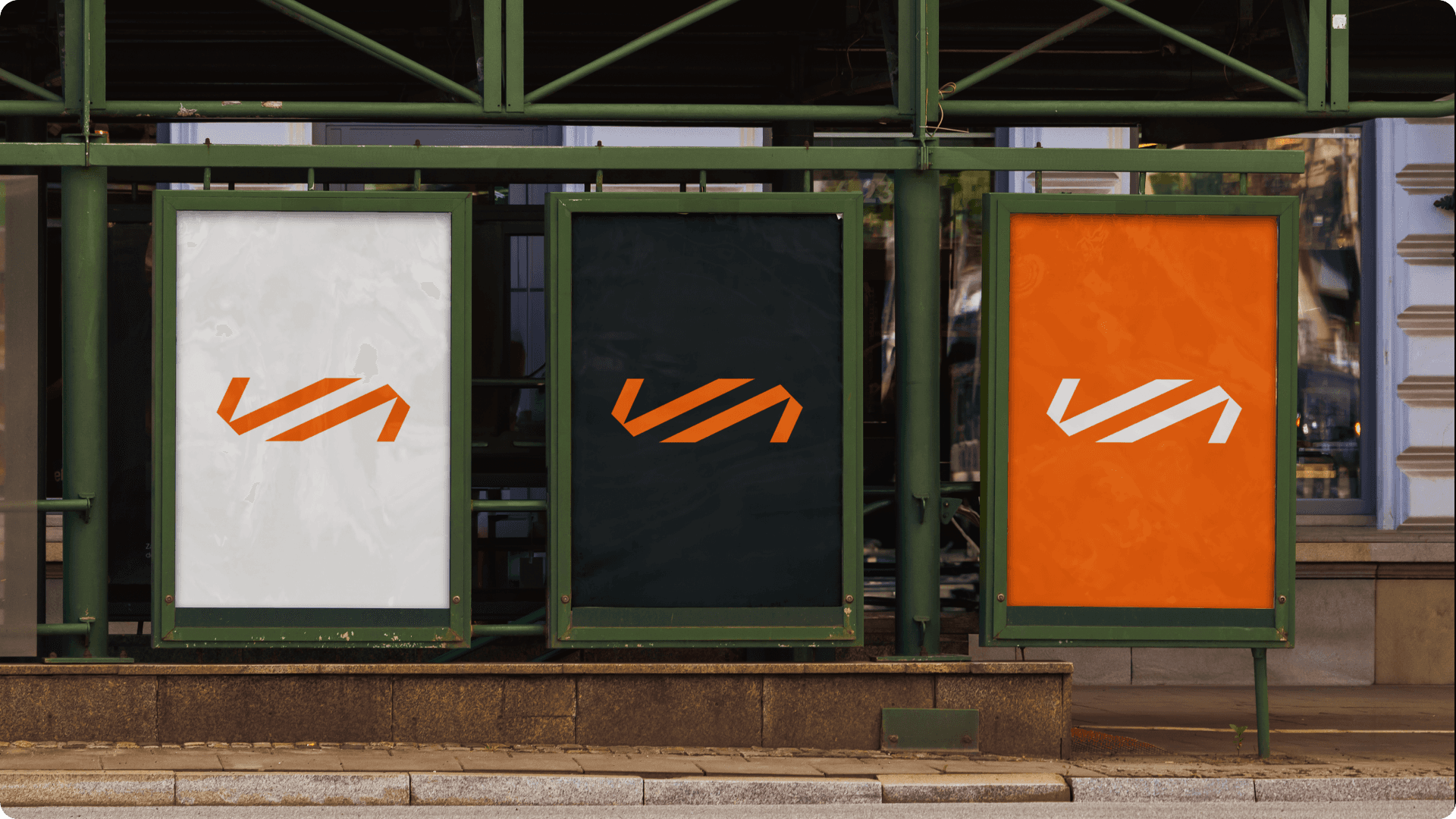 Portrait of a woman with curly hair wearing a two-tone gray and orange beanie against a neutral background.