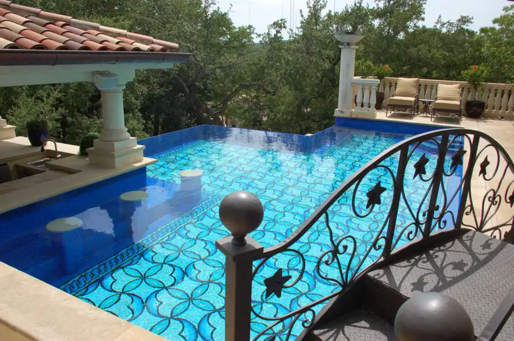 Vibrant geometric mosaic glass pool with intricate tile design on Lake Austin.