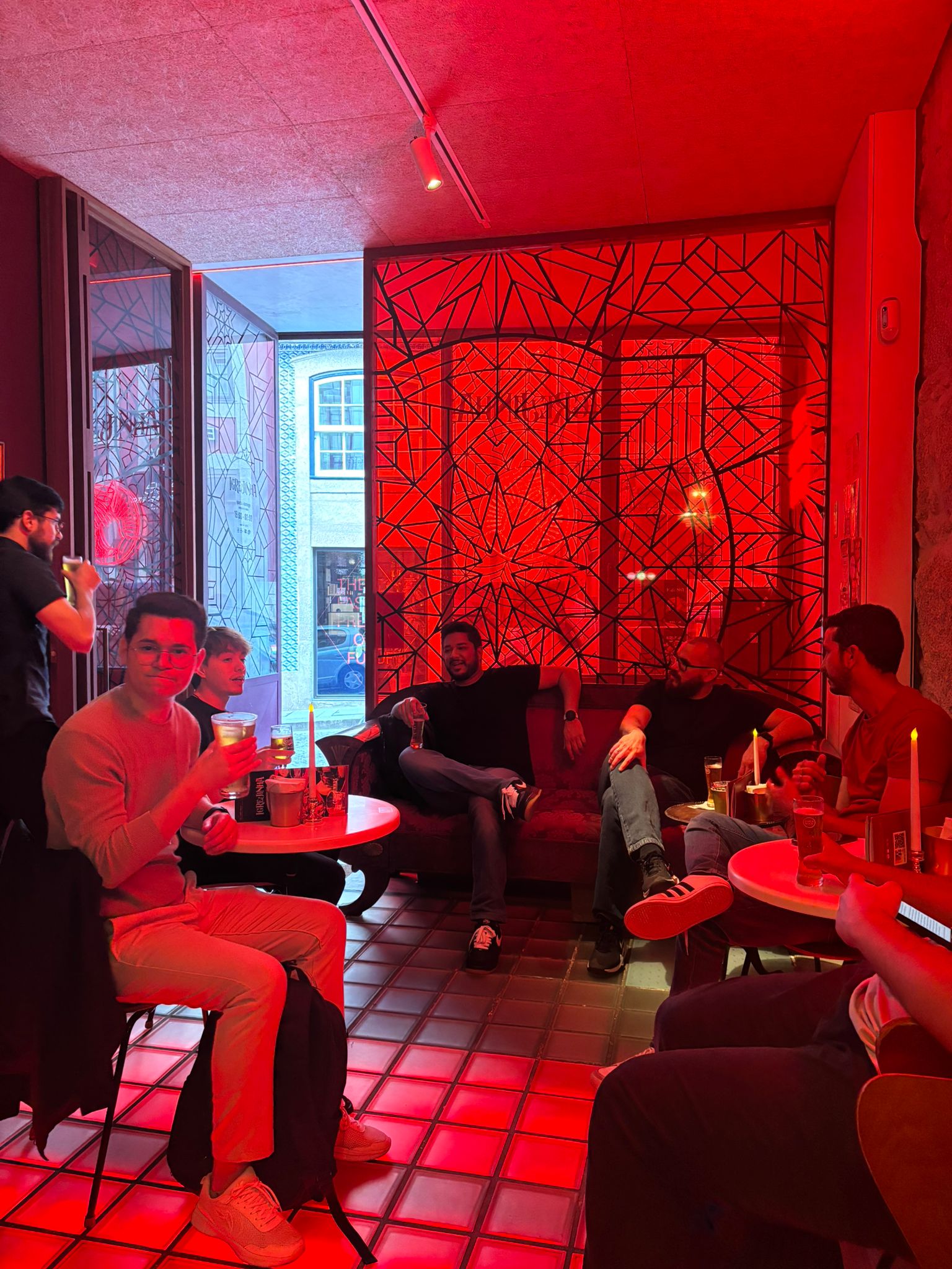 Six coworkers chilling at a bar during a team meeting.