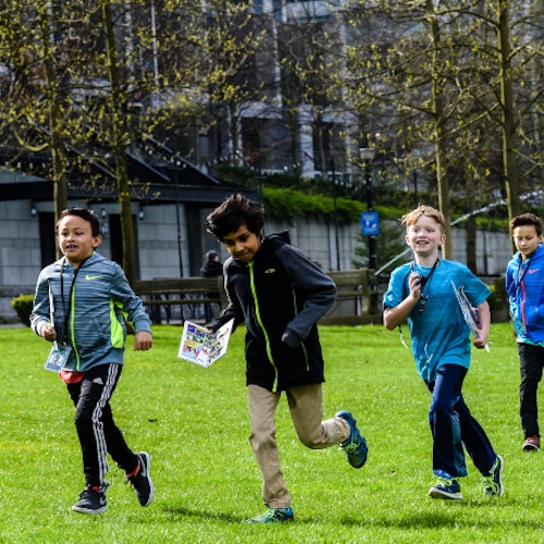 A group of kids in a park in Vancouver BC in Coal Harbour