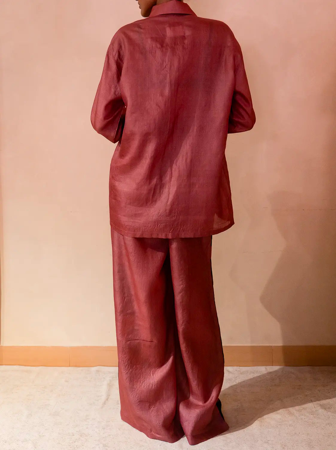 A relaxed co-ord set featuring a simple silk shirt, Designed for effortless wear