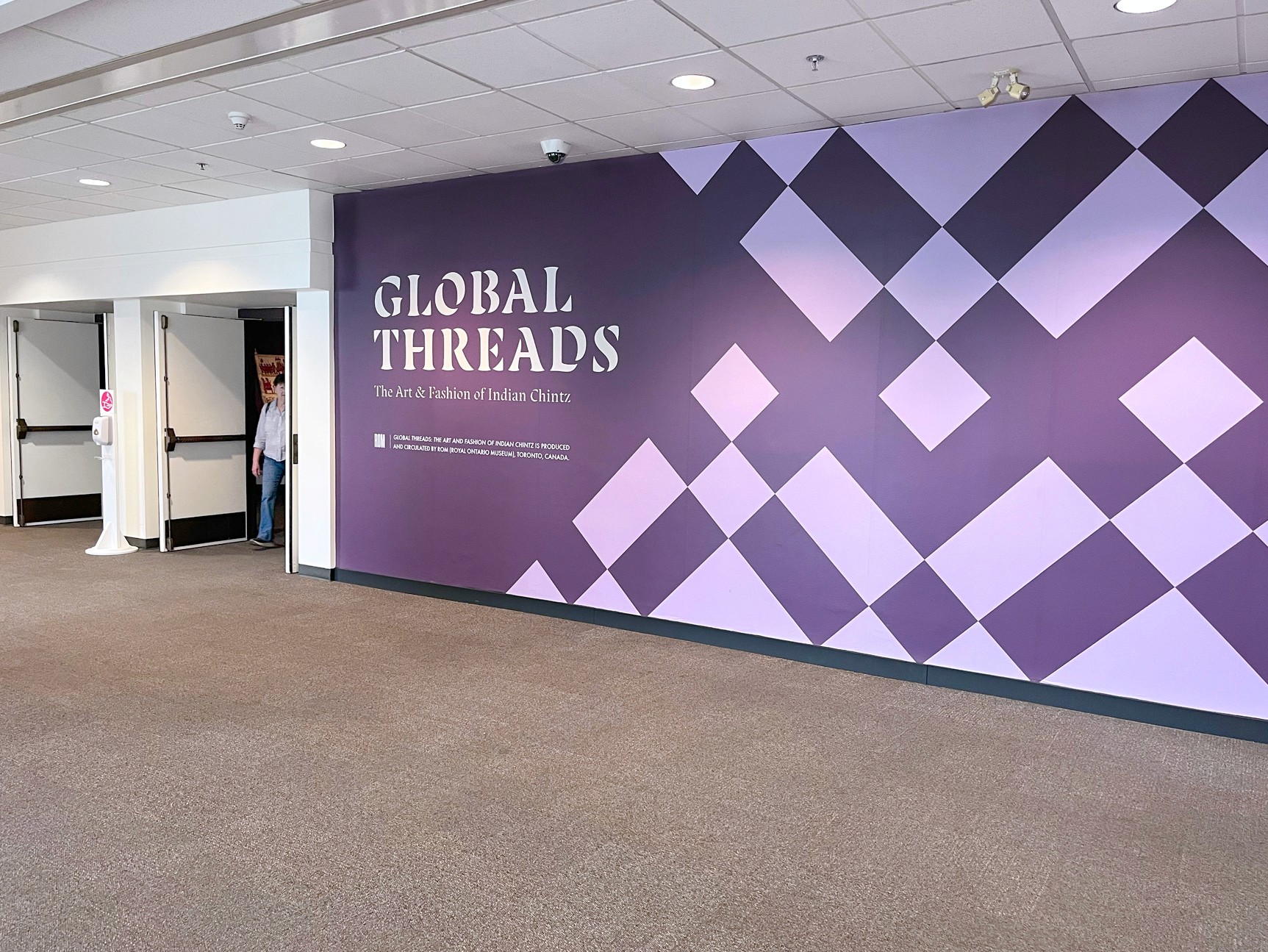 Entry wall graphic next to the entrance to the exhibition Global Threads