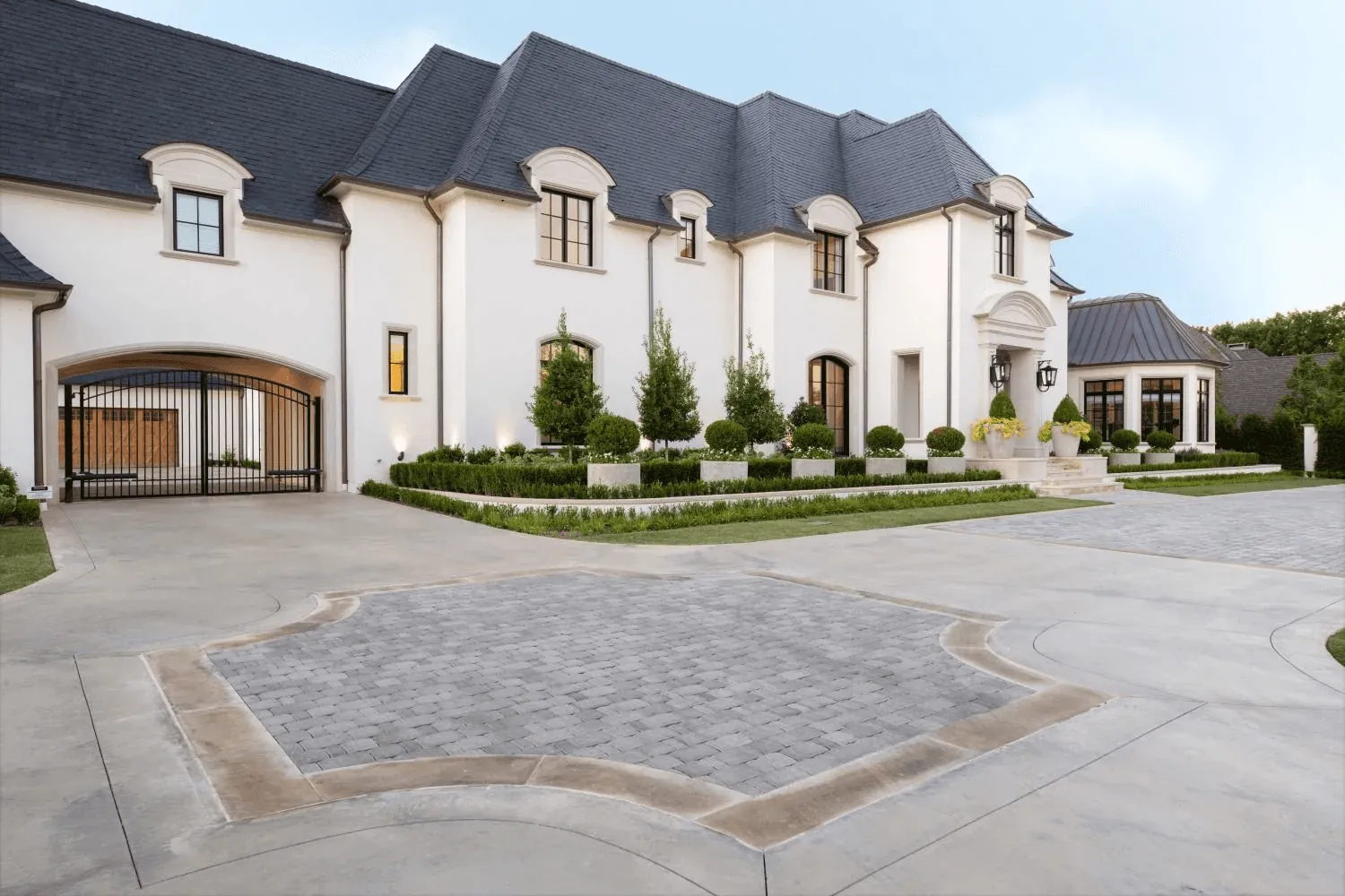 Formal front garden design with sculptural fountains for luxury Preston Hollow Dallas estate