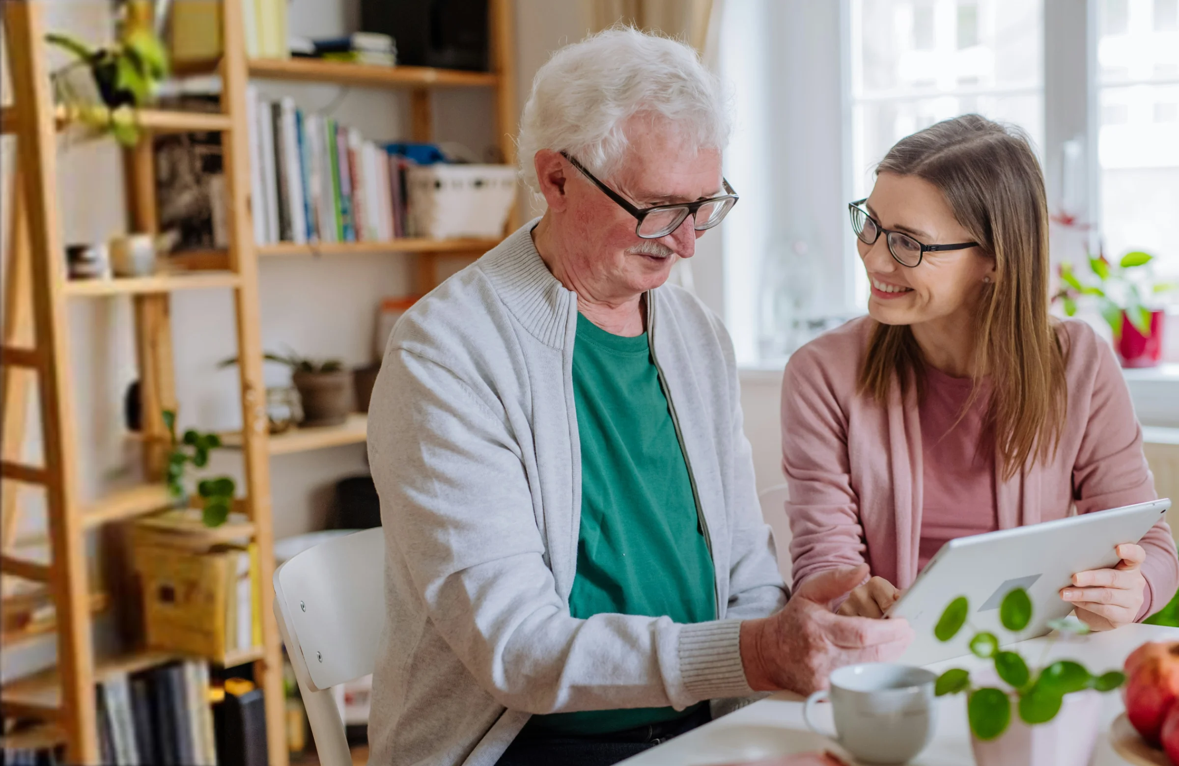 Community nurse discussing health assessment with older client at home in Brisbane