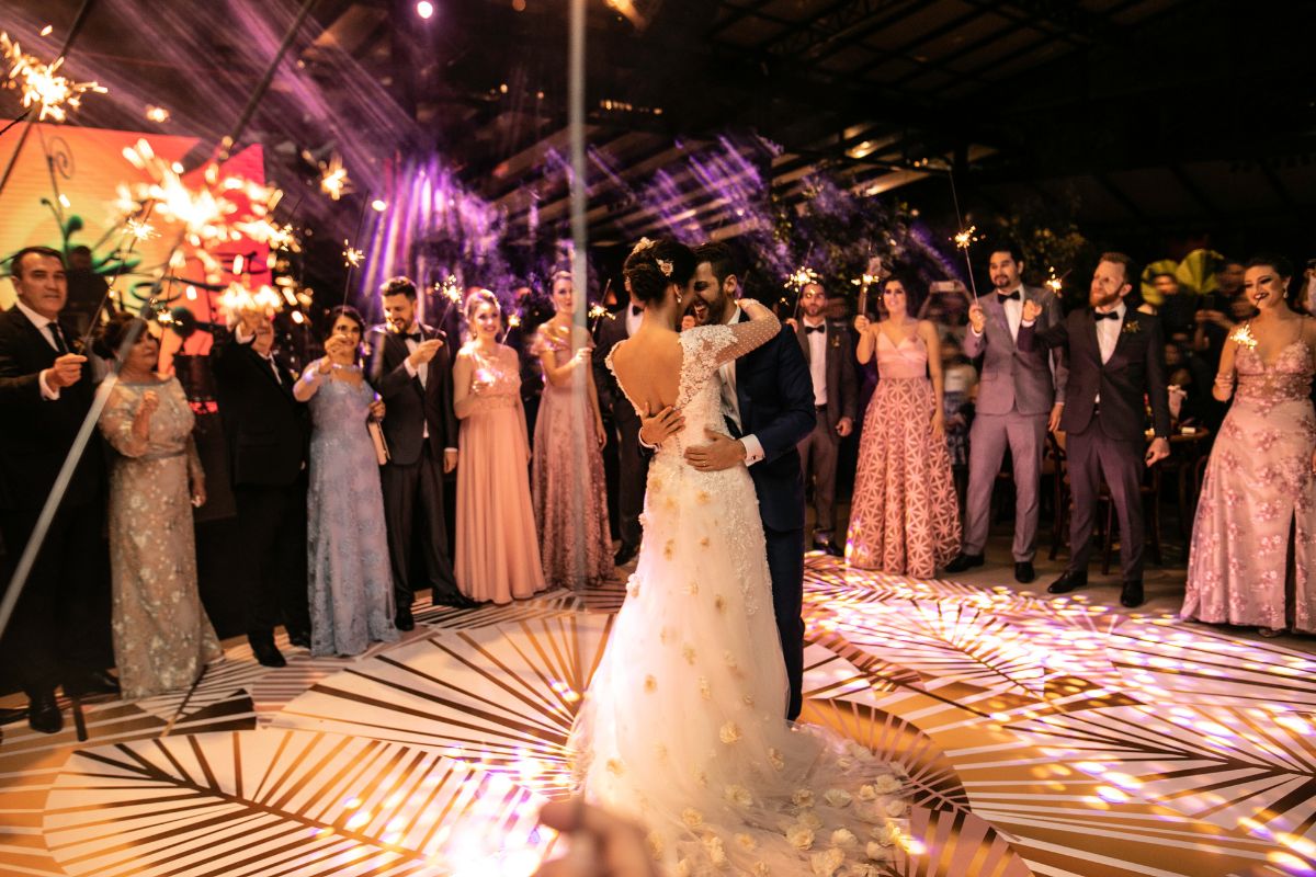 Wedding couple dancing together with friend and family sharing the moment.