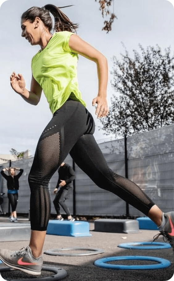 woman wearing a green shirt and nike shoes running