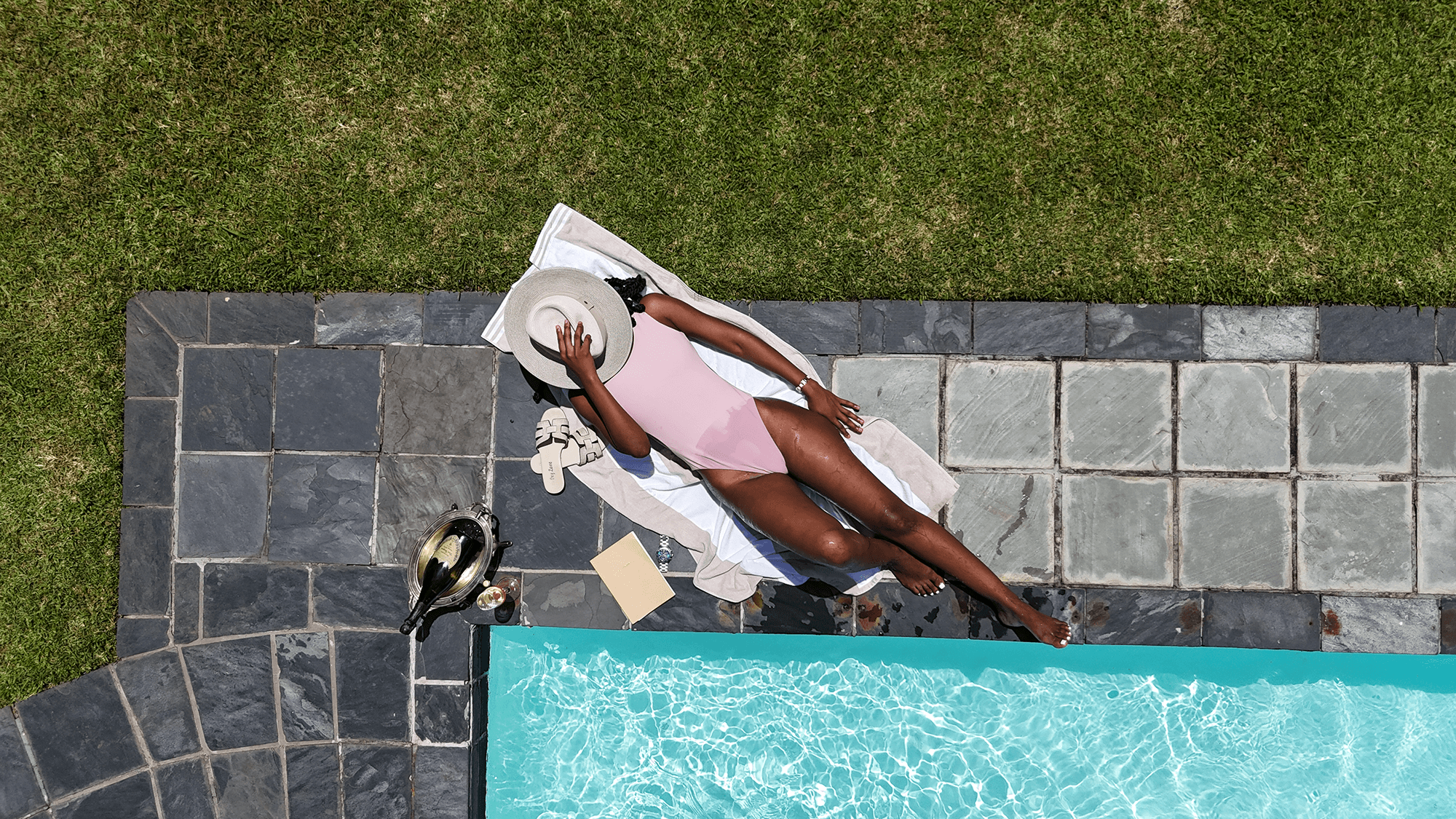 Sparkling outdoor swimming pool surrounded by lush gardens at Redlands Hotel.
